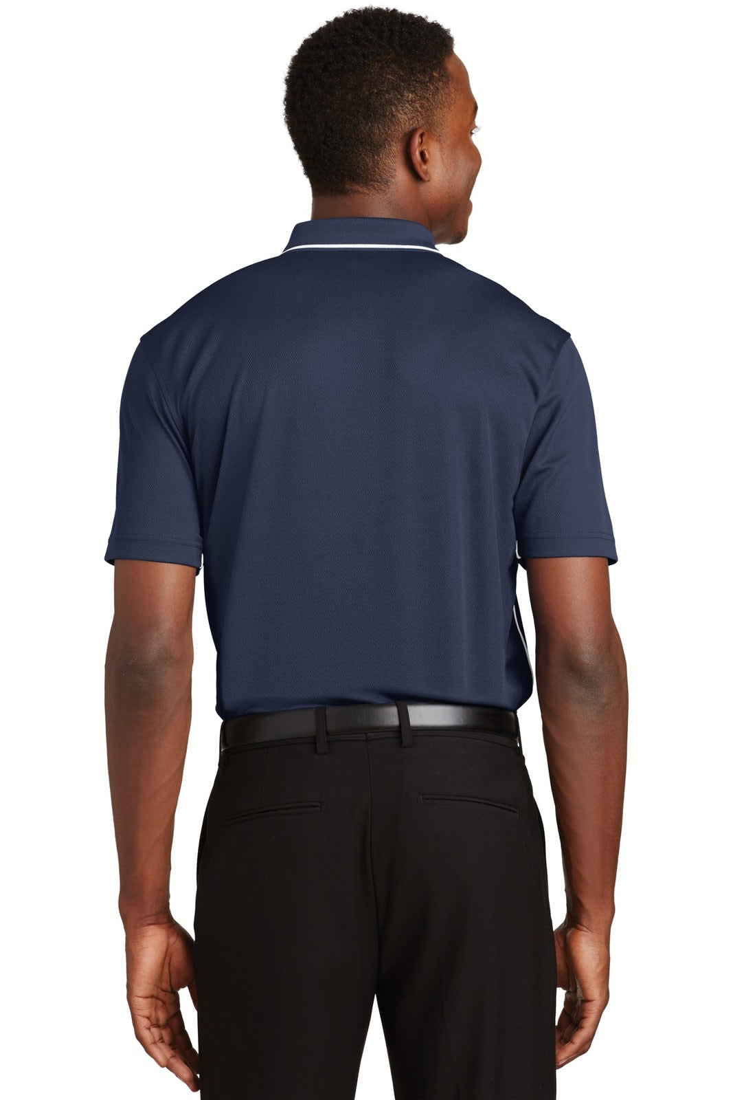 A navy polo shirt with a tipped collar and piping, featuring a logo, seen from the back on a model.