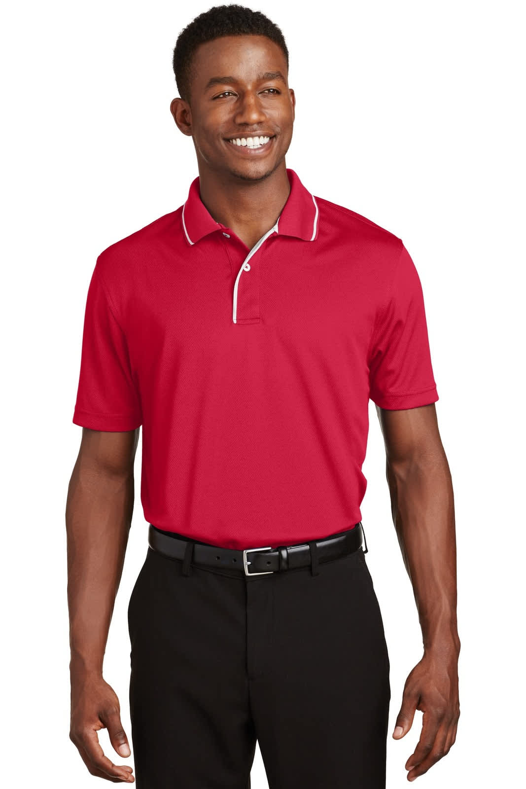A red Sport-Tek Dri-Mesh polo shirt featuring a tipped collar and piping, modelled by a smiling man.