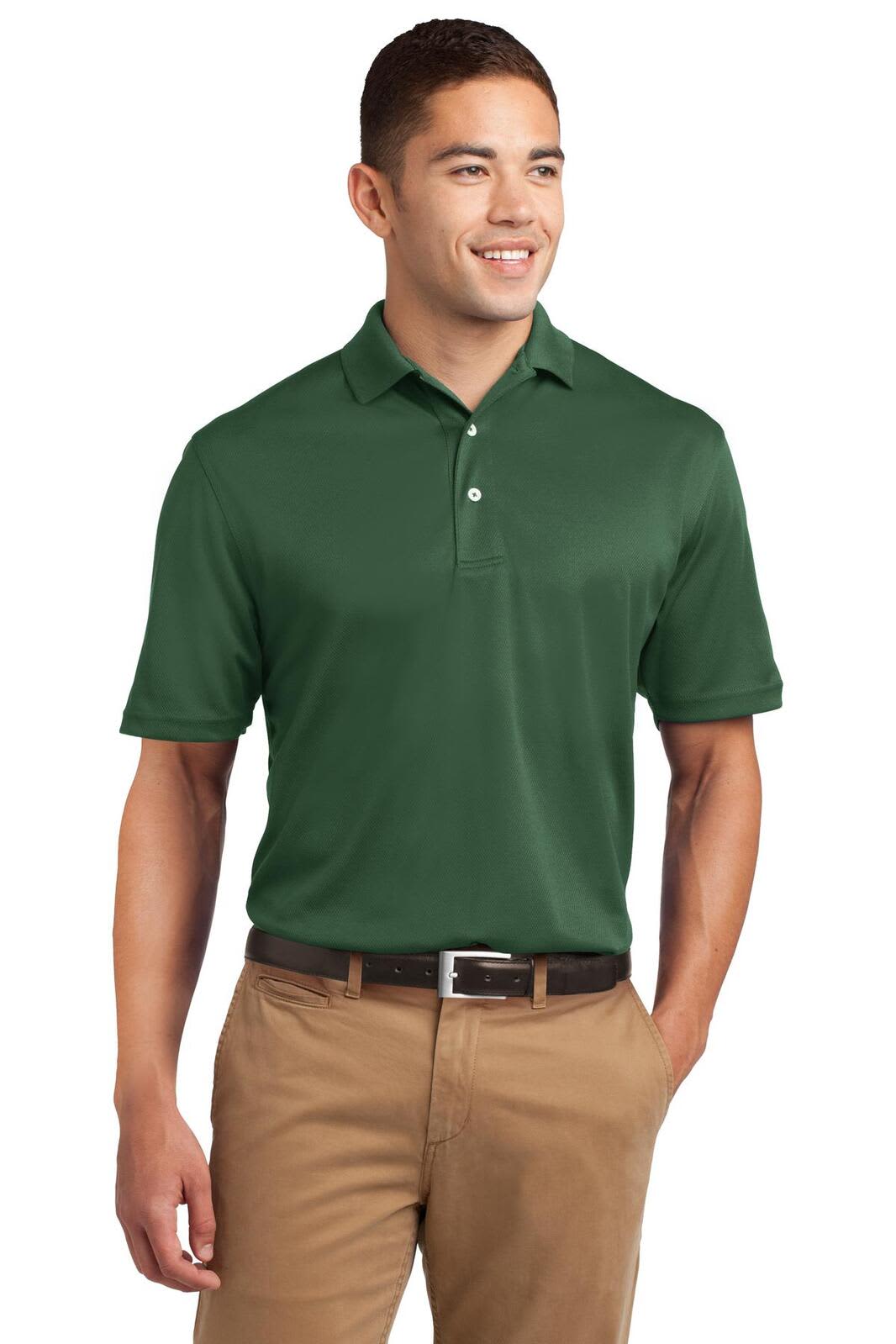 A man wearing a green Sport-Tek Dri-Mesh polo shirt, paired with beige trousers, with a logo on the shirt.