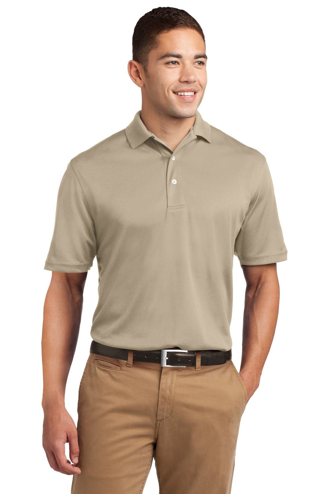 A man wearing a beige Sport-Tek Dri-Mesh polo shirt, paired with tan pants and a black belt. The shirt has a logo.
