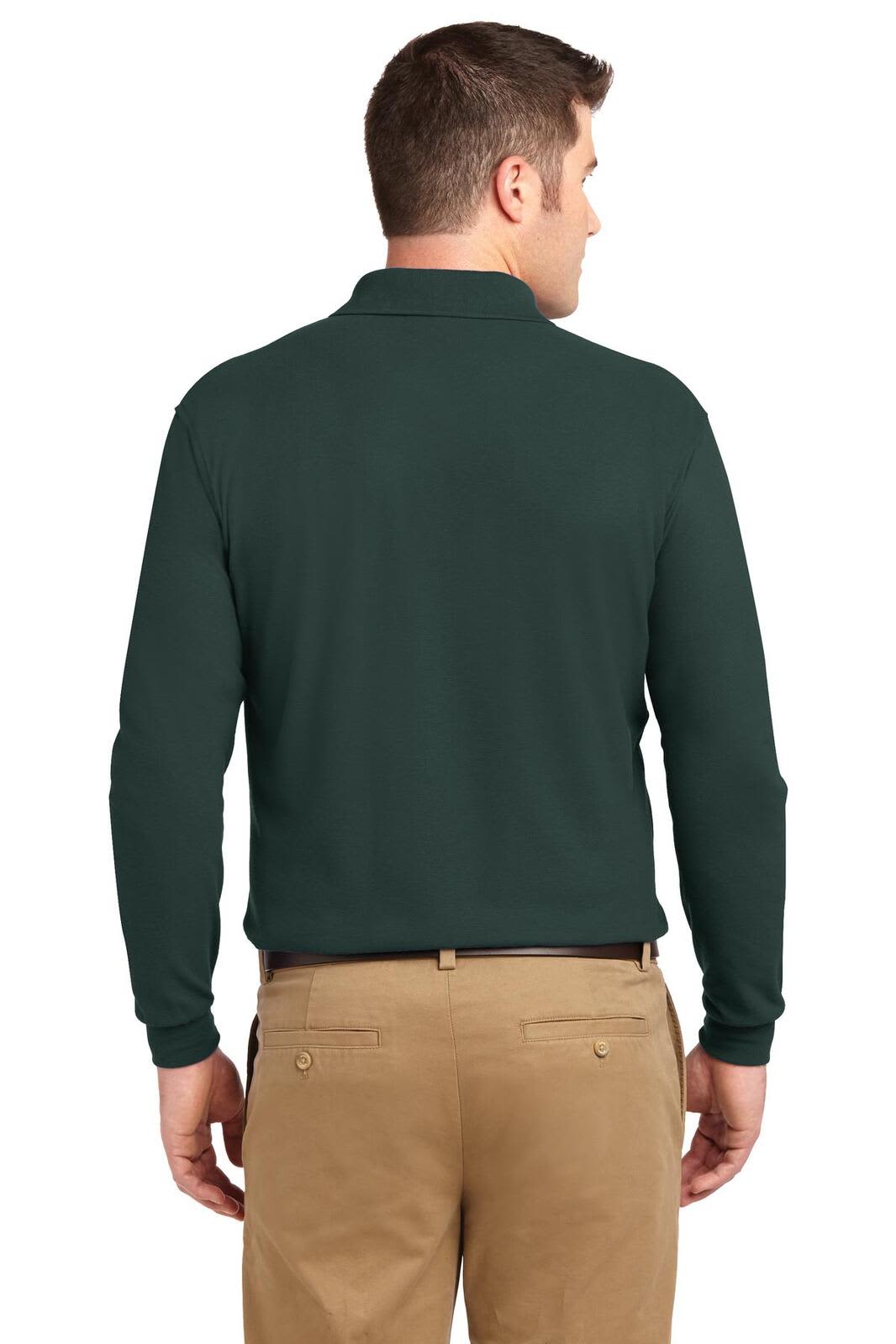 A man wearing a dark green long sleeve polo shirt, viewed from the back, with light tan pants. The shirt has a logo.