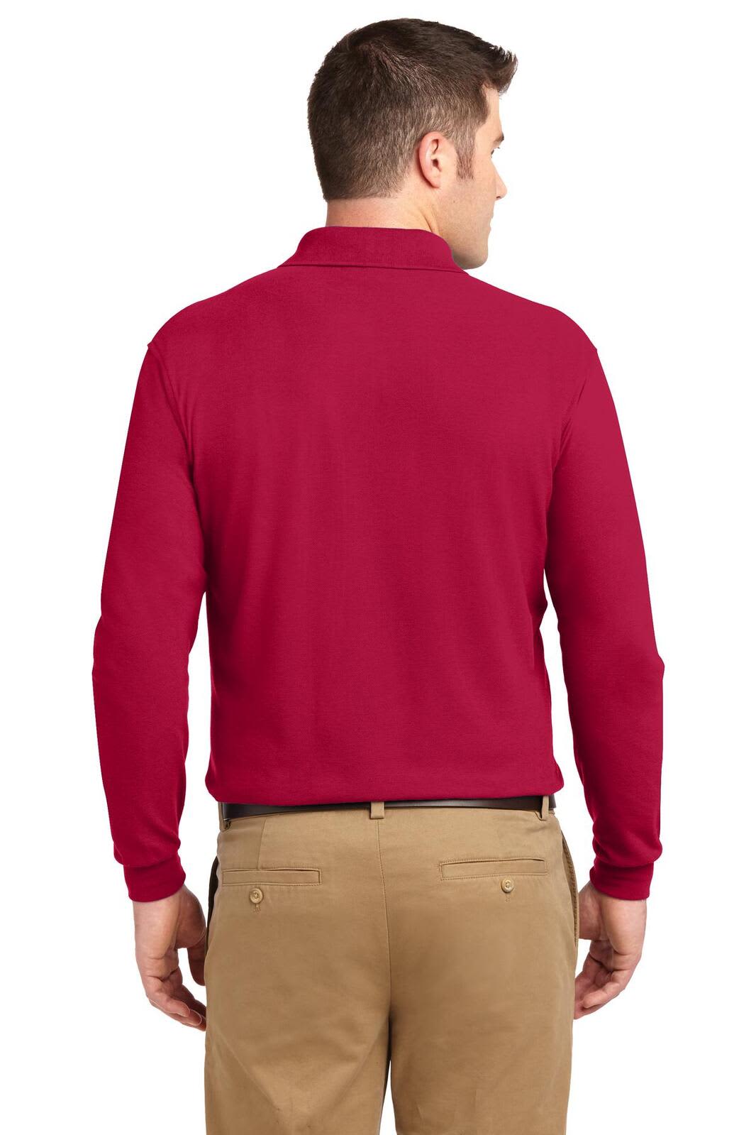 A long sleeve polo shirt in a bold red colour, featuring a logo on the back, paired with khaki pants.