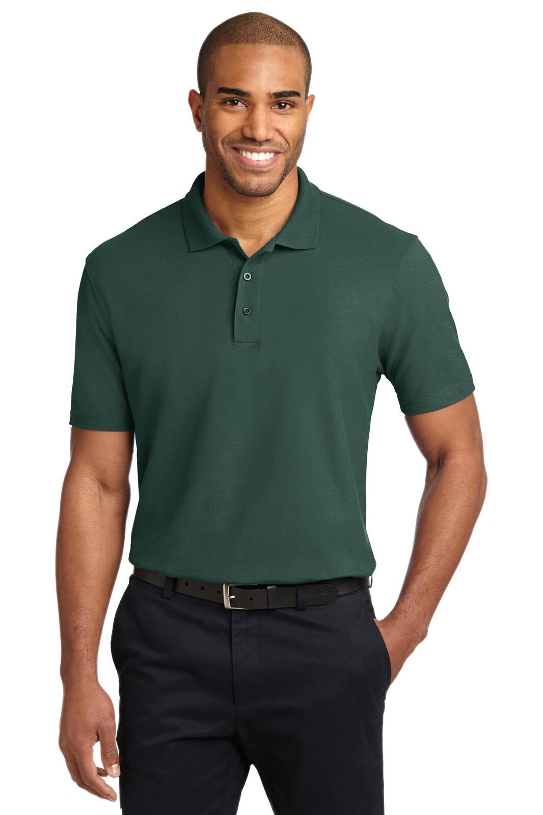 A green stain-resistant polo shirt displayed on a male model, paired with dark trousers. The shirt features a logo.