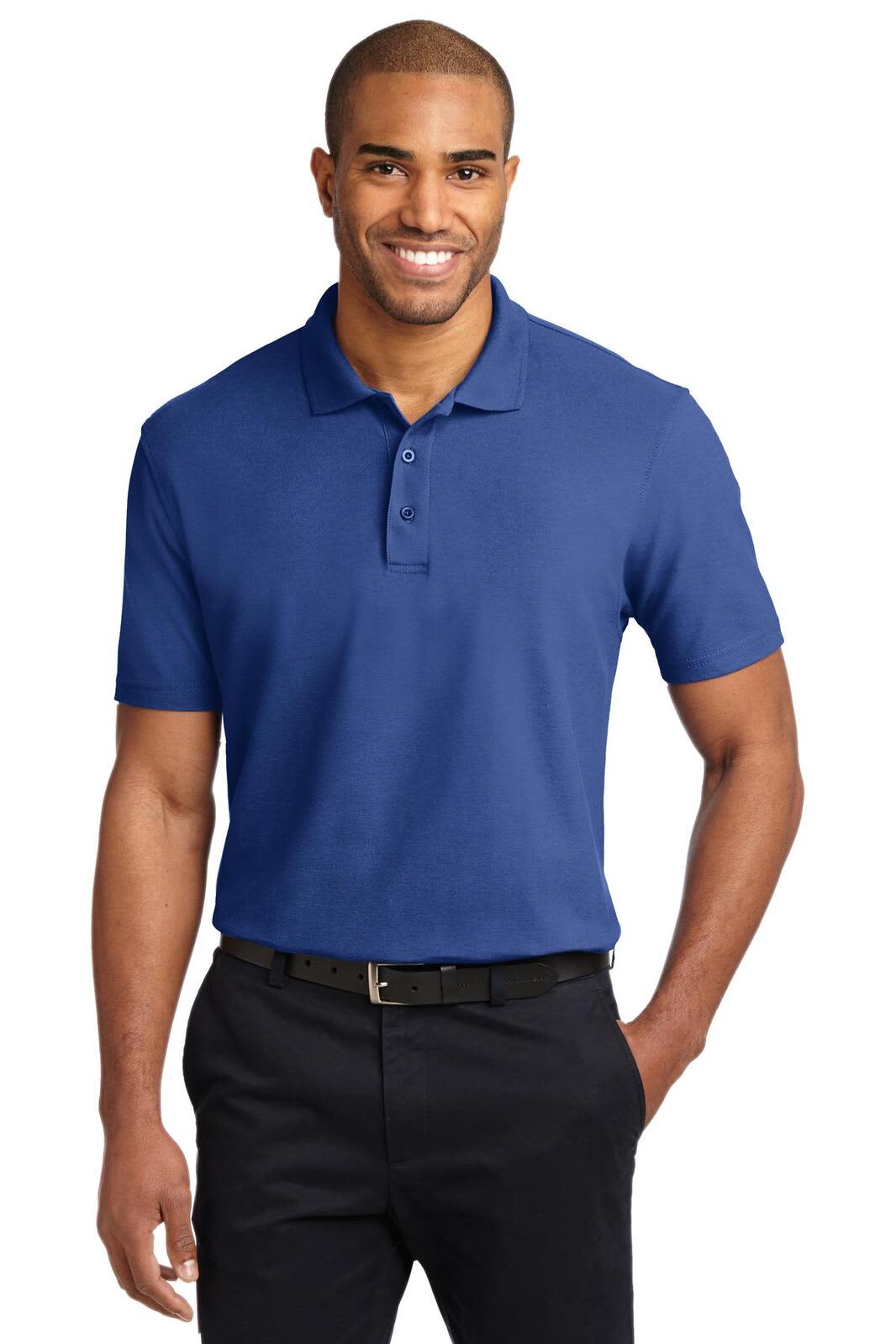 A man wearing a blue stain-resistant polo shirt, paired with black trousers, and featuring a logo on the shirt.