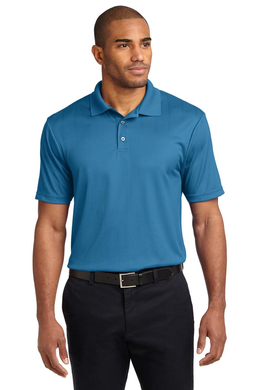 A man wearing a blue Port Authority Performance Fine Jacquard polo shirt, paired with black trousers. The shirt features a logo.