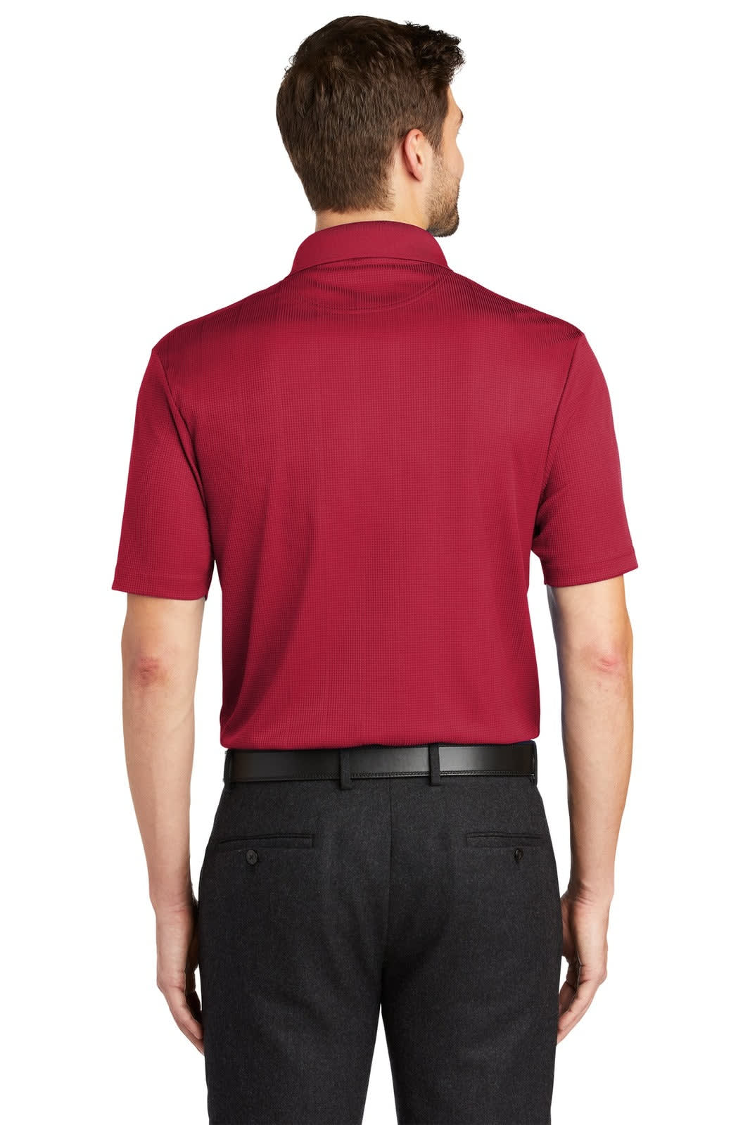 A red polo shirt with short sleeves, featuring a collar and a logo on the back, paired with dark trousers.