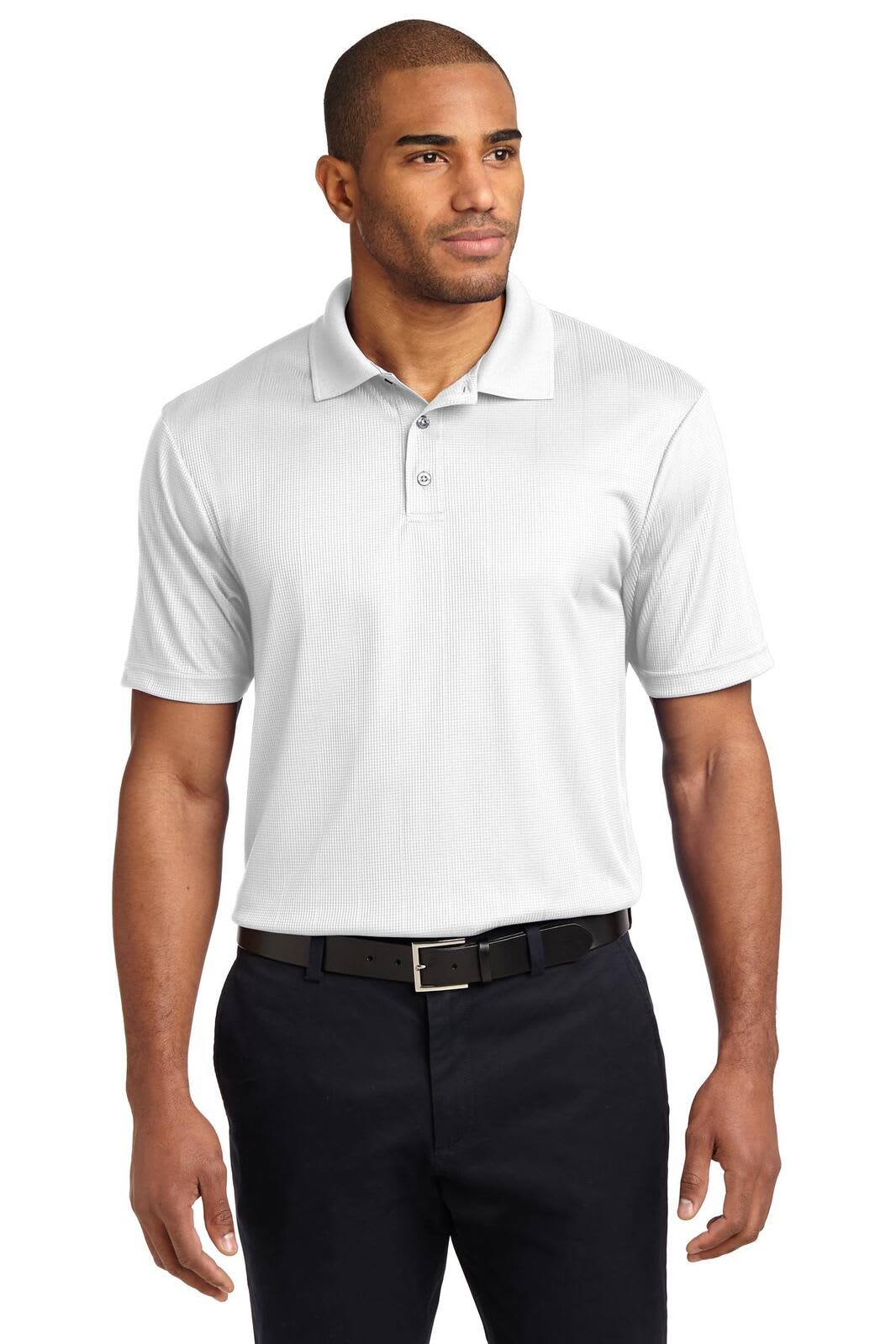 A man wearing a white Port Authority Performance Fine Jacquard Polo shirt, paired with dark trousers. The shirt has a logo.
