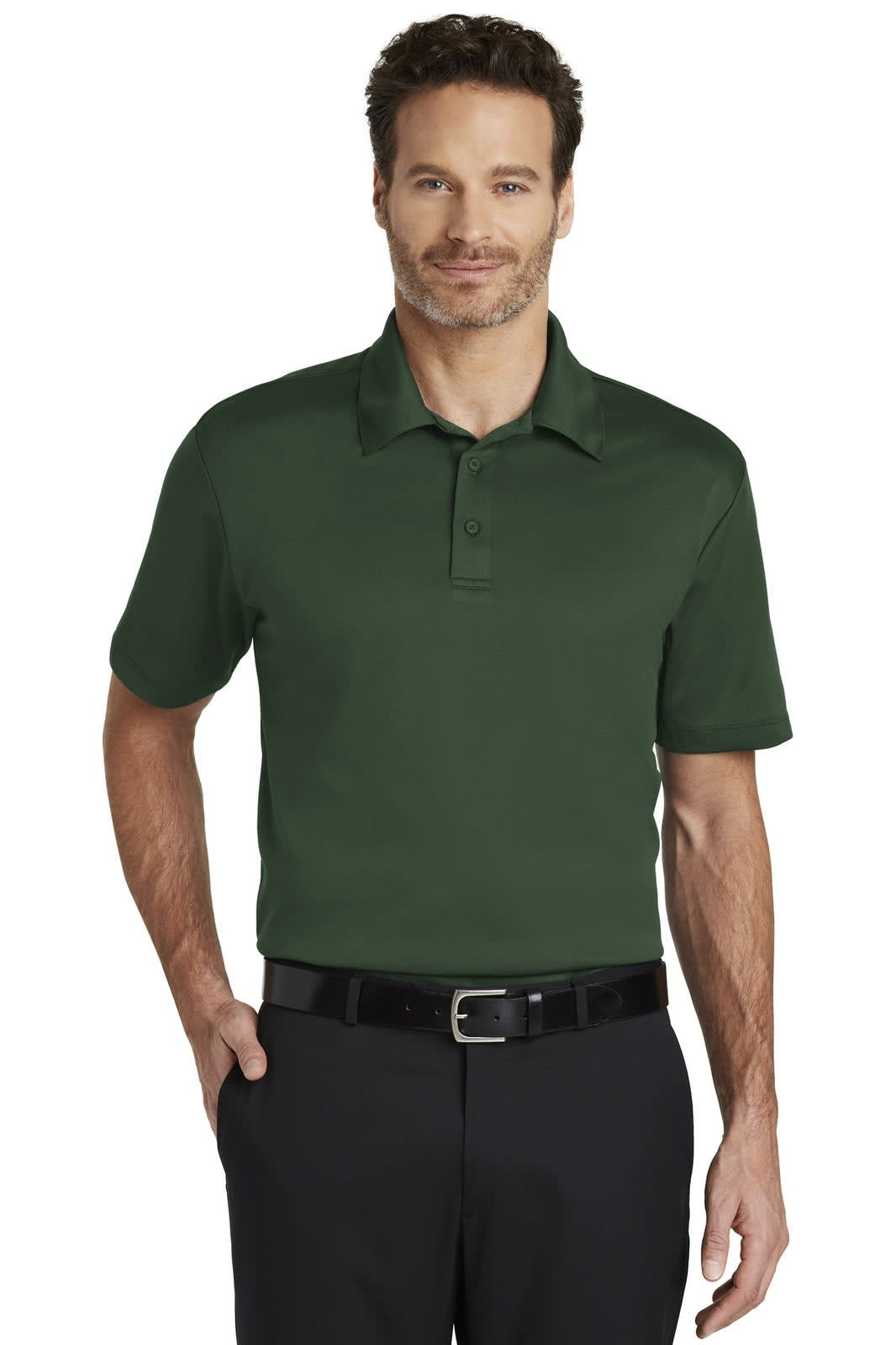 A man models a dark green Port Authority Silk Touch Performance Polo shirt, featuring a logo on the chest.