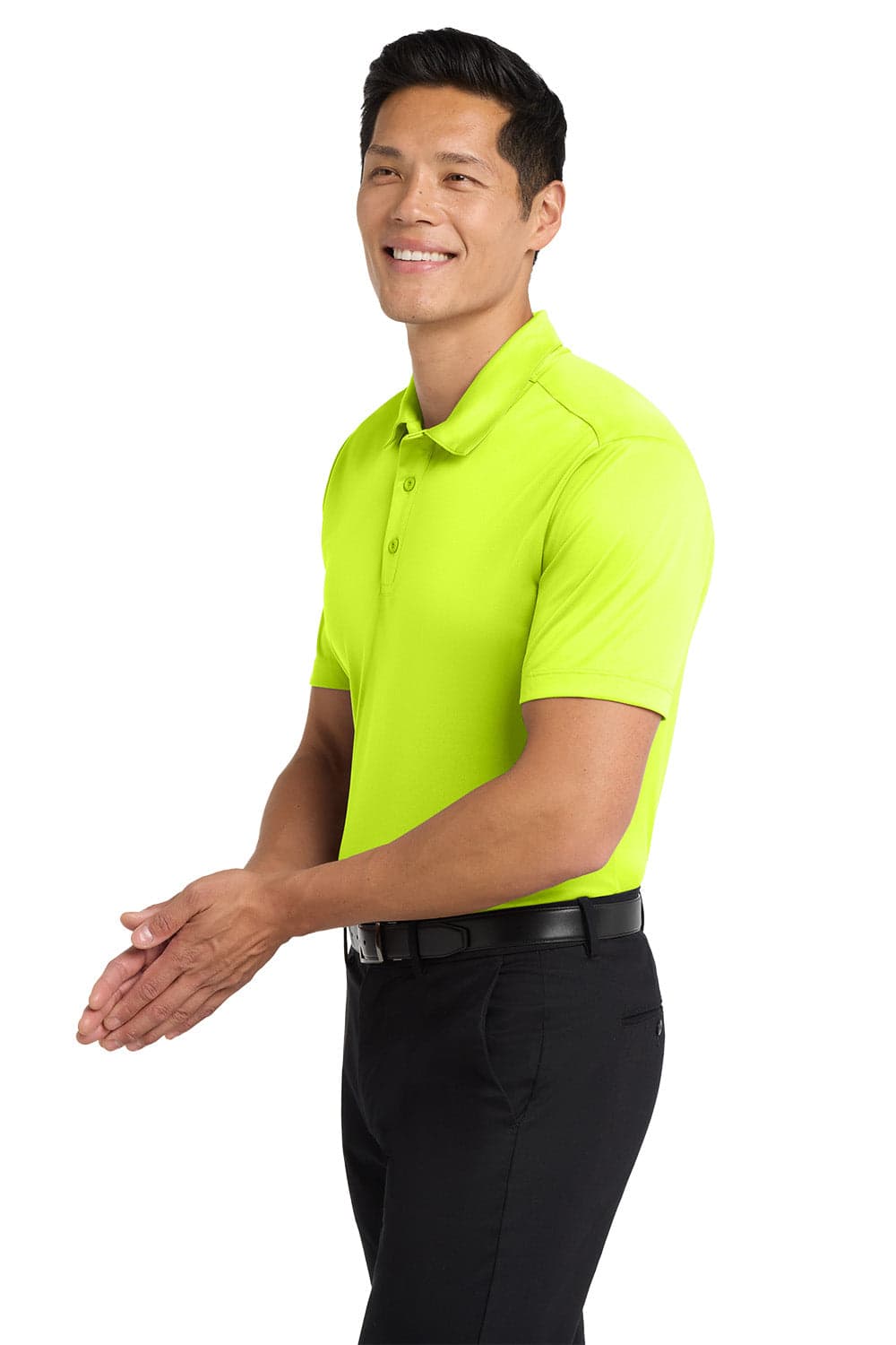 A bright lime green polo shirt worn by a smiling man, paired with black trousers. The shirt features a logo.