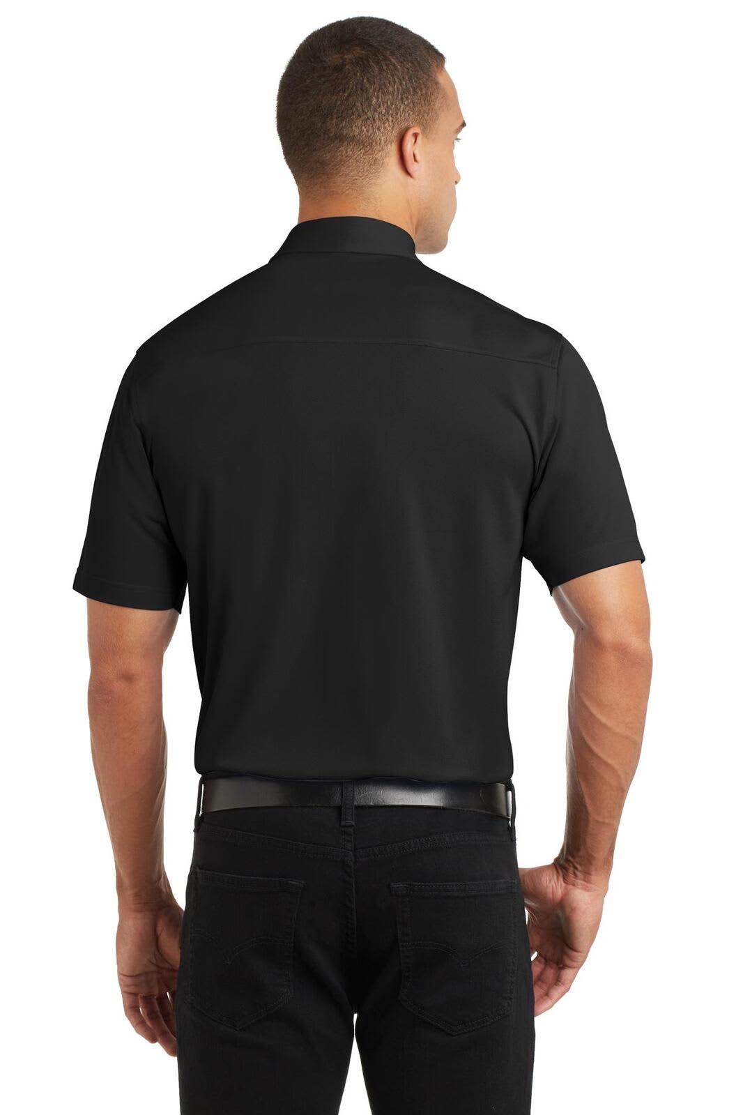 A man is wearing a black polo shirt, viewed from the back, featuring a logo on the collar.