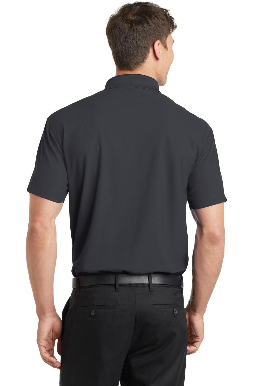 A man wearing a dark grey polo shirt, view from the back, paired with black trousers. The shirt has a brand logo.