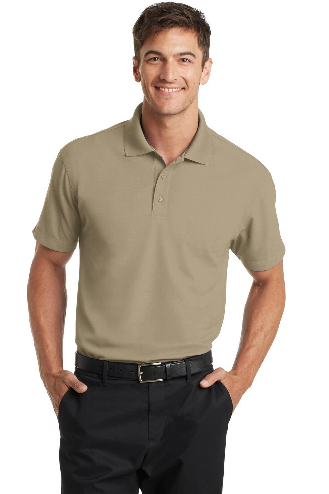 A male model wearing a khaki polo shirt with a collar, paired with dark pants, featuring a logo on the shirt.