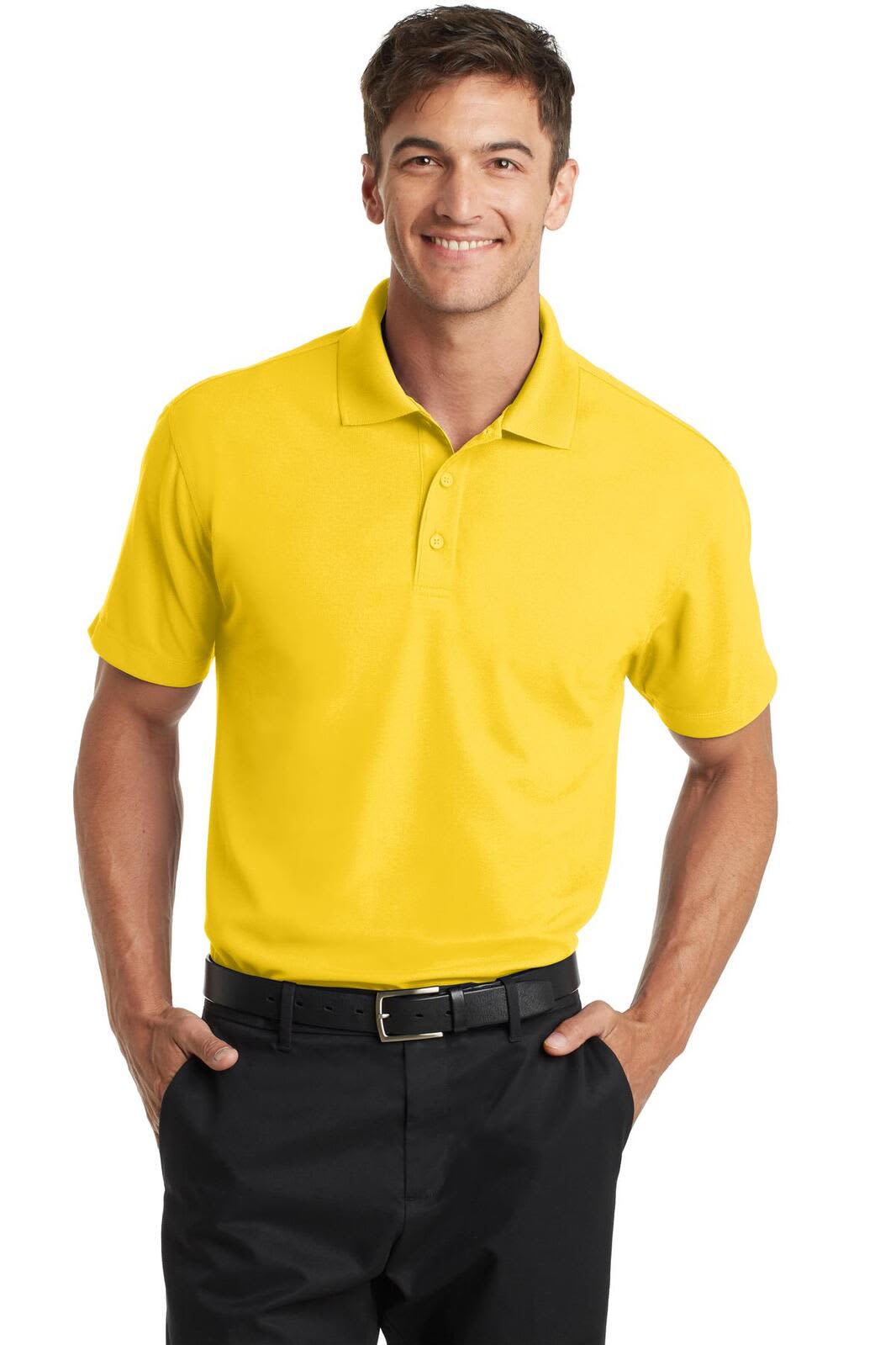 A man wearing a bright yellow polo shirt with a collar, paired with black trousers. The shirt features a logo.