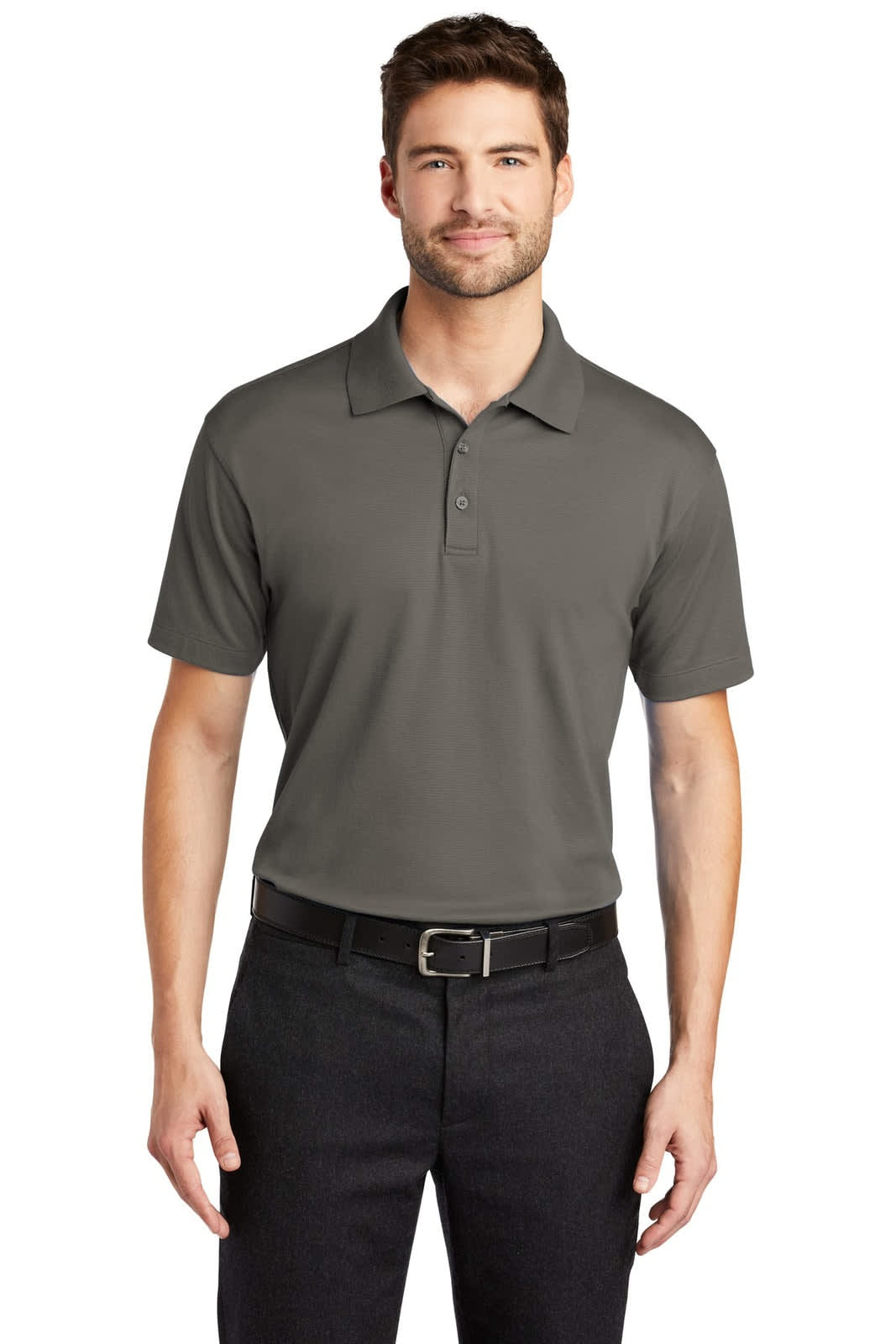 A man wearing a dark grey polo shirt with a collar, paired with black trousers. The shirt features a logo on the chest.