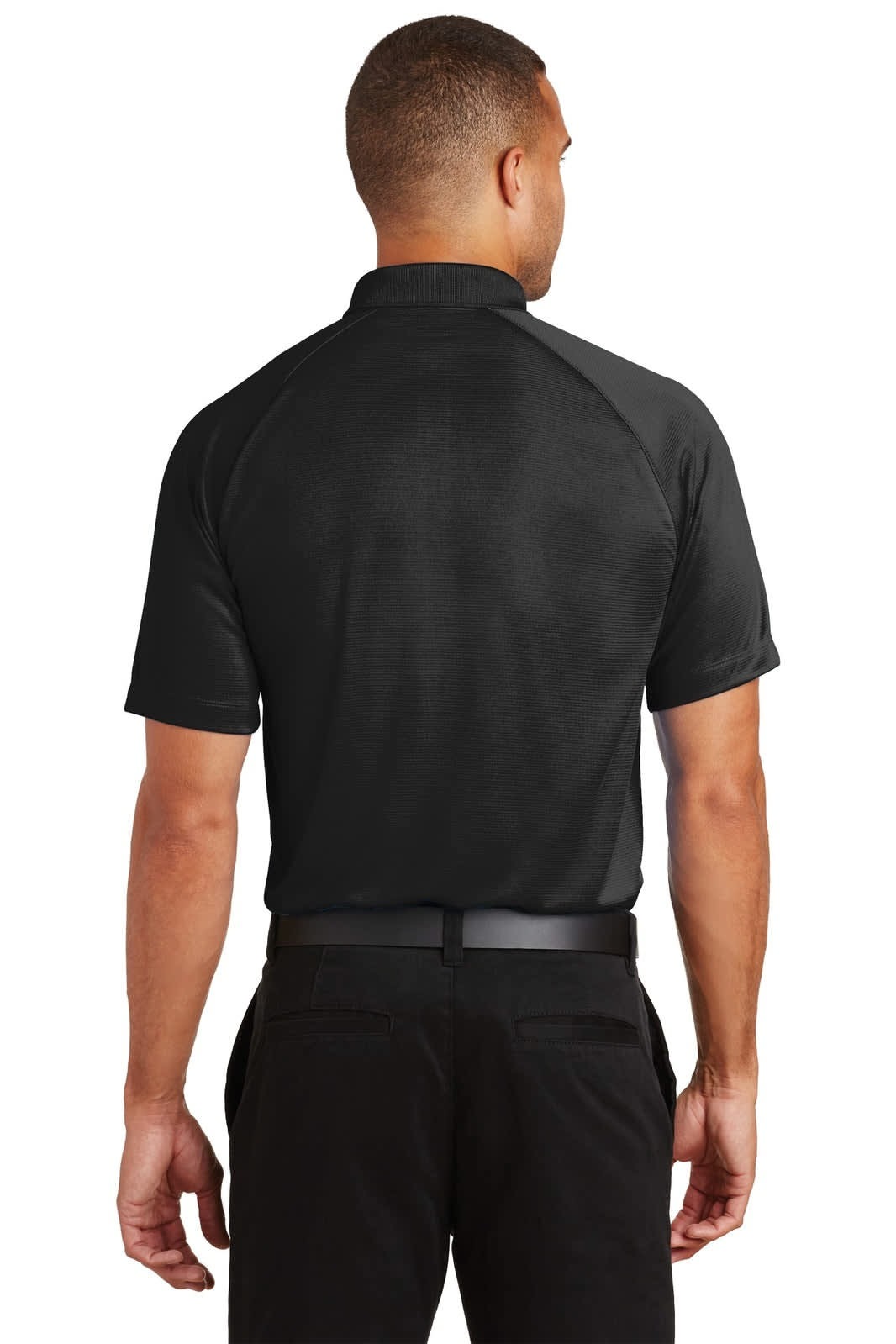 A black Port Authority Crossover Raglan Polo shirt displayed on a model from the back, featuring a logo on the collar.