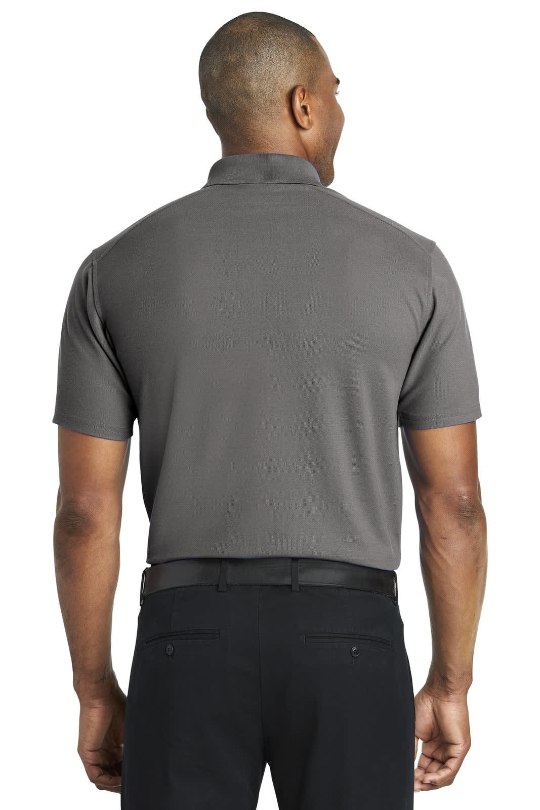 A grey polo shirt viewed from the back, featuring short sleeves and a collar. The model wears black trousers.