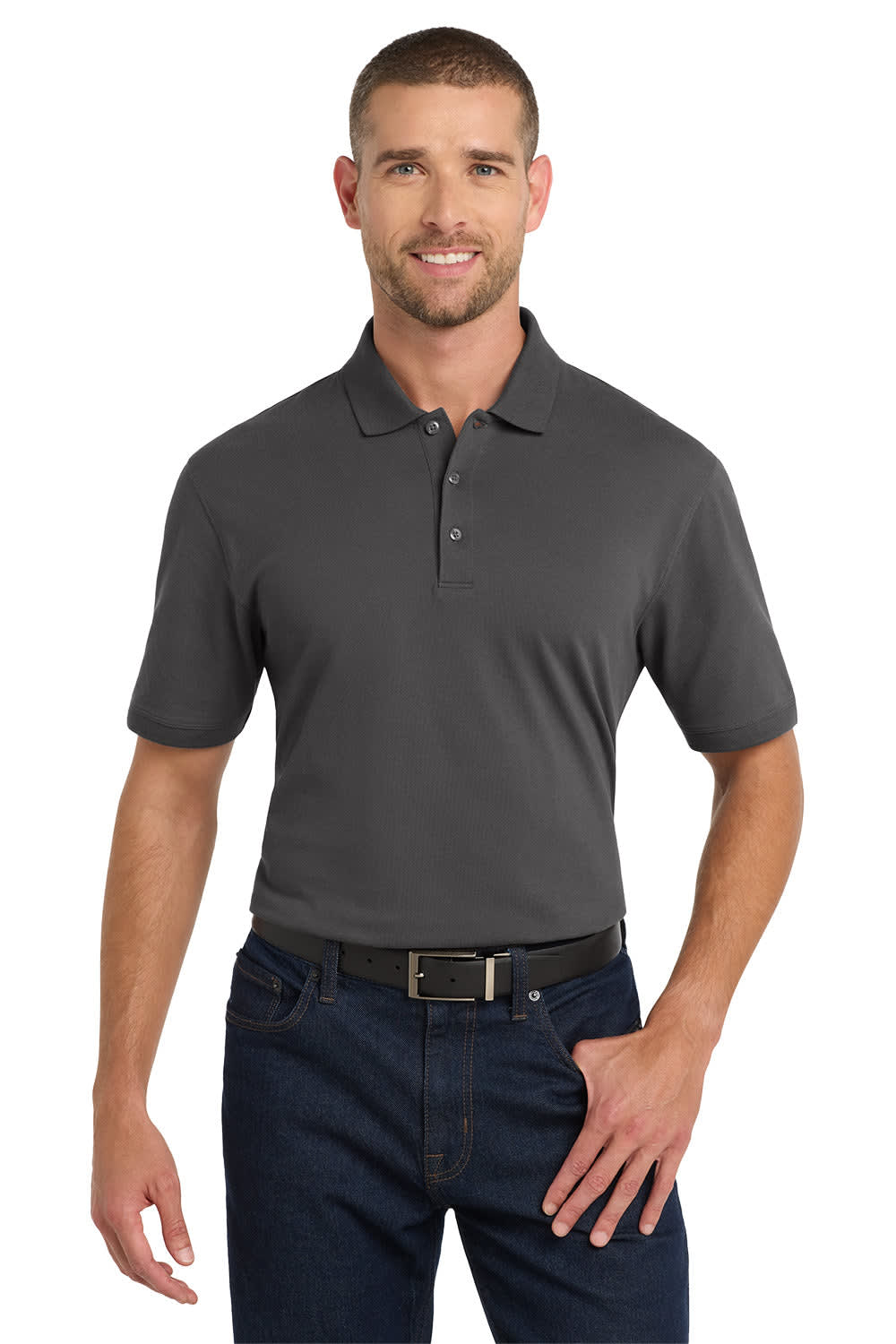 A man is wearing a short-sleeved, charcoal grey polo shirt with a logo on the chest. He has dark jeans and a belt.