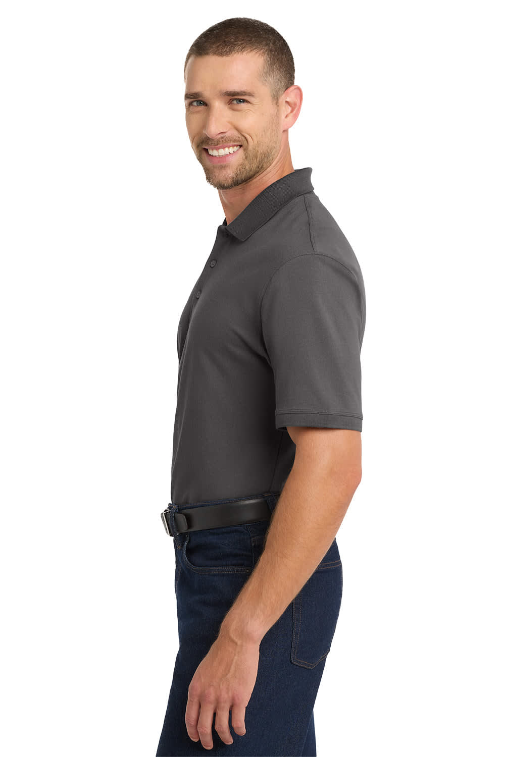 A charcoal grey polo shirt displayed on a model, featuring a logo on the chest and paired with navy trousers.
