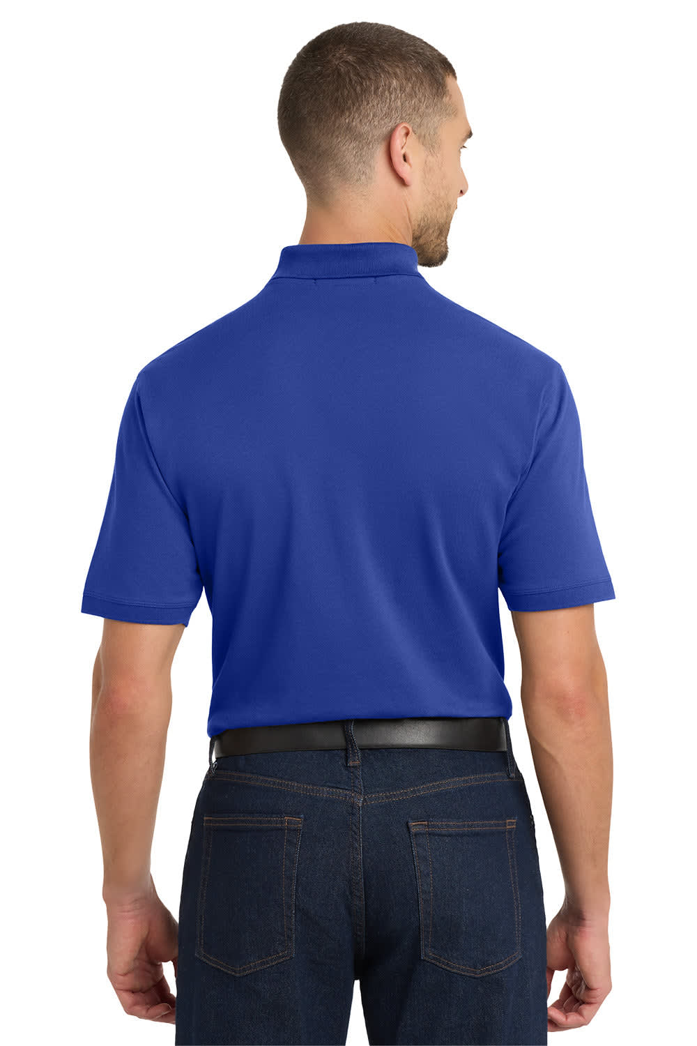 A man wearing a blue Port Authority EZCotton polo shirt, viewed from the back, with denim jeans.
