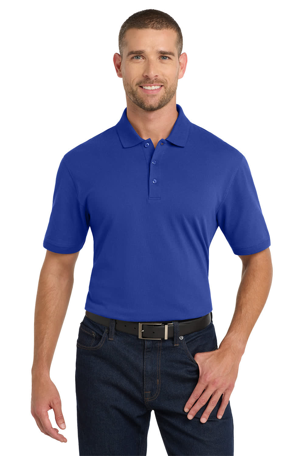A man wearing a blue Port Authority EZCotton polo shirt, paired with dark jeans, featuring a logo on the left chest.