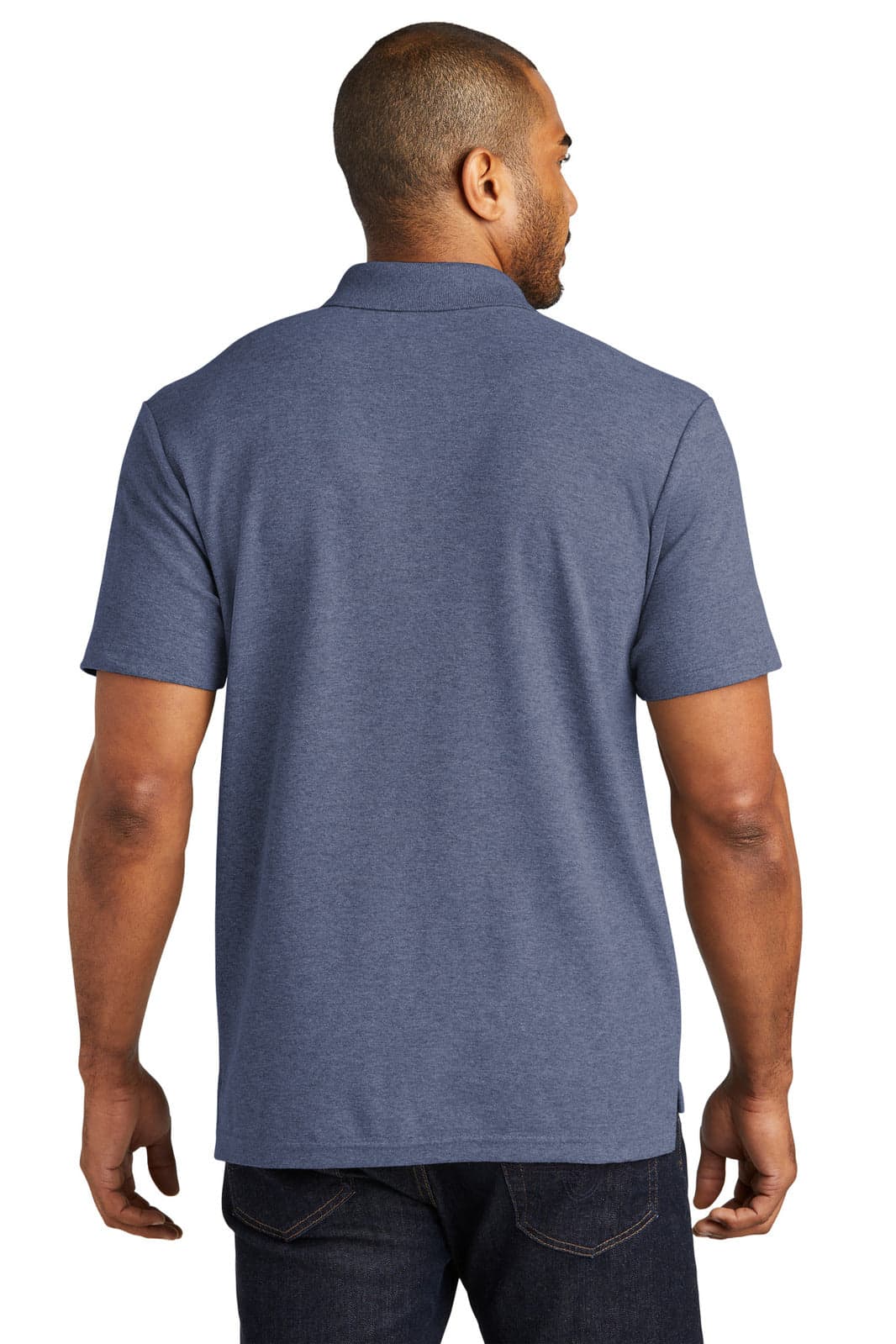 A man wearing a navy blue Port Authority C-FREE cotton blend pique polo shirt from the back. The shirt features a collar and short sleeves.