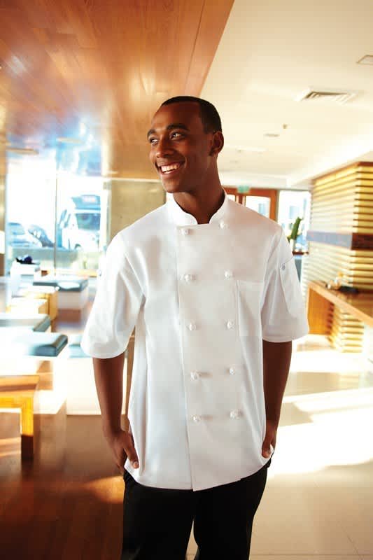 A white men's chef jacket worn by a smiling man, featuring a classic design and short sleeves.