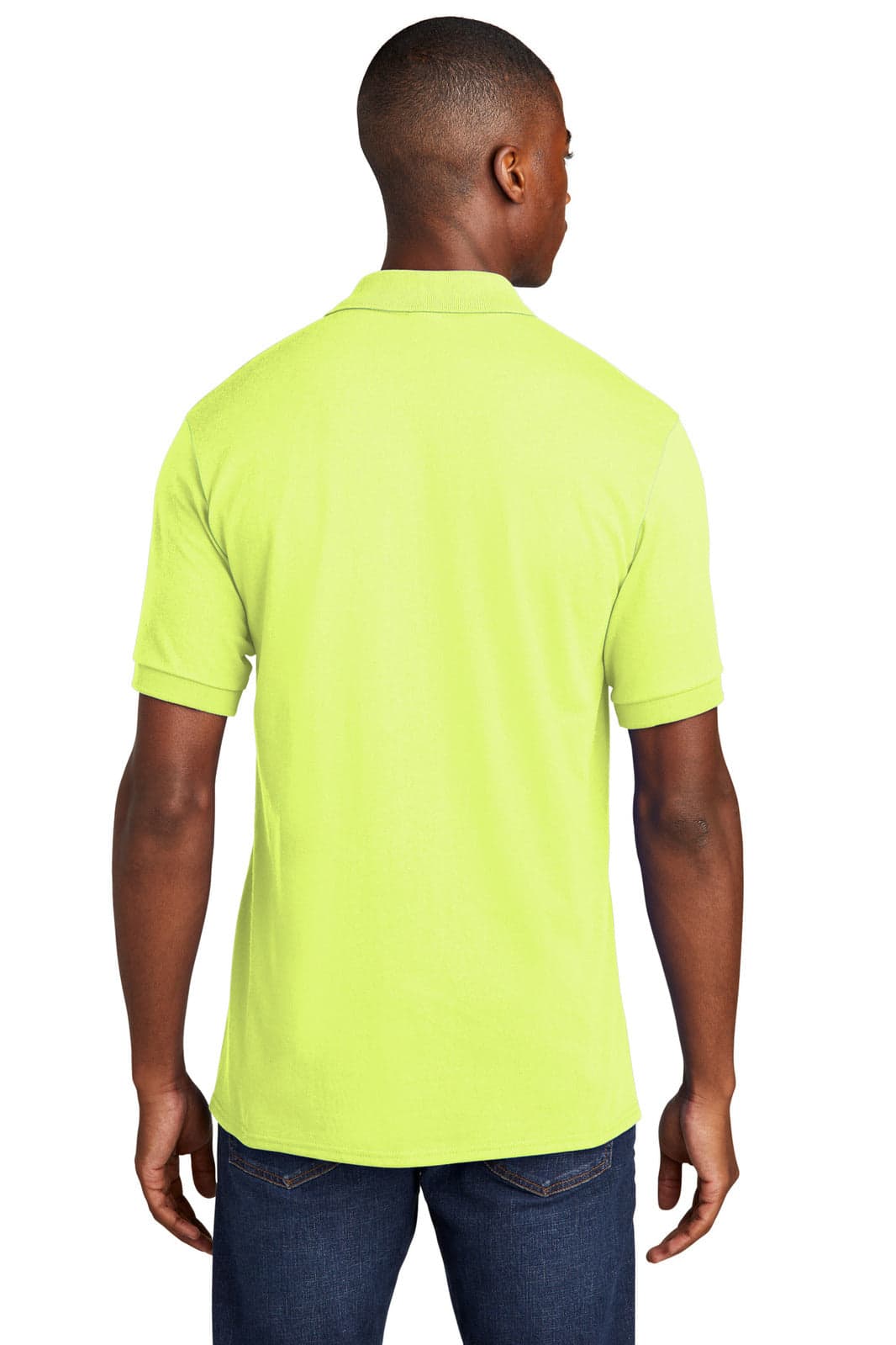 A man wearing a bright yellow polo shirt, viewed from the back, featuring a logo on the chest.