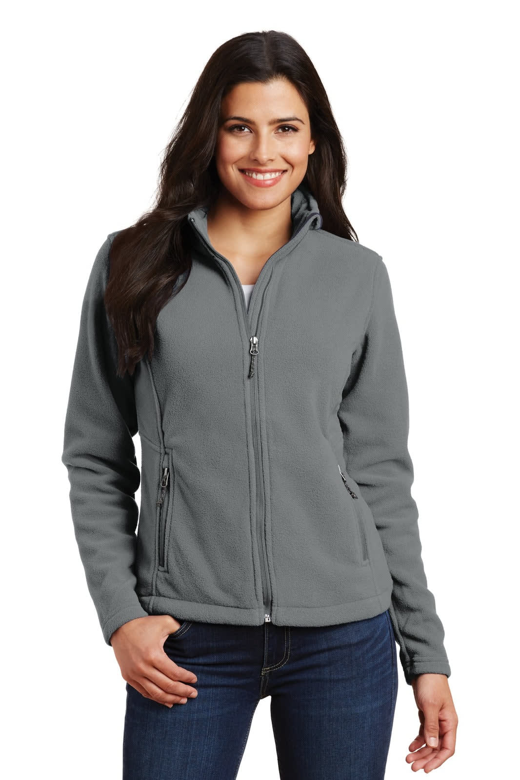 A grey fleece jacket for women with a zip front and side pockets. The model is smiling and wearing jeans.