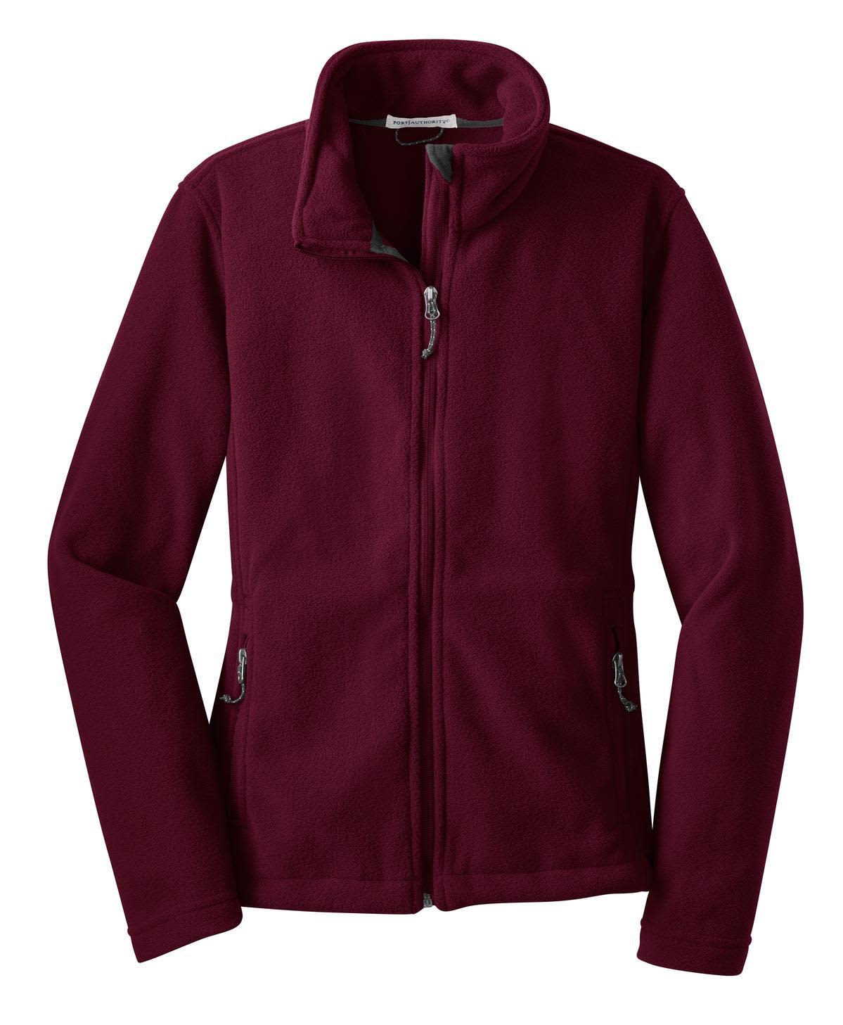 A maroon ladies’ fleece jacket with a zippered front and side pockets, featuring branding on the chest.