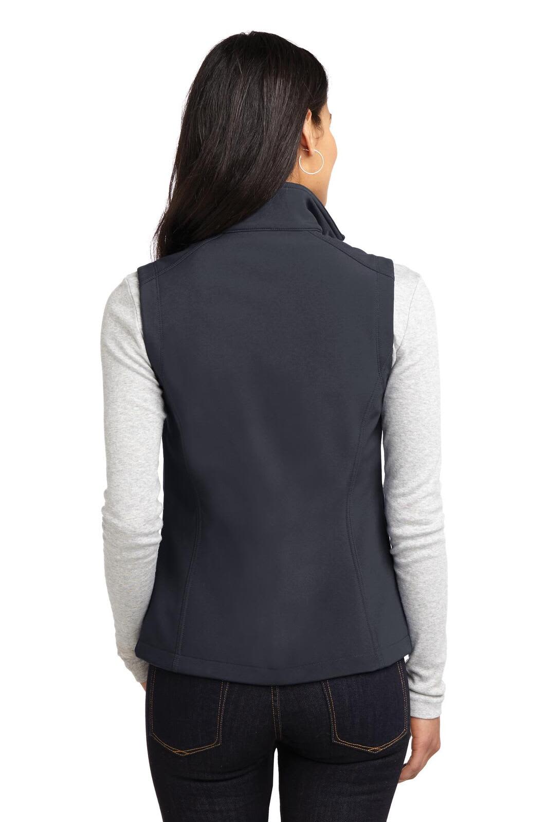 A dark navy soft shell vest is shown from the back, worn over a light grey long-sleeve top.