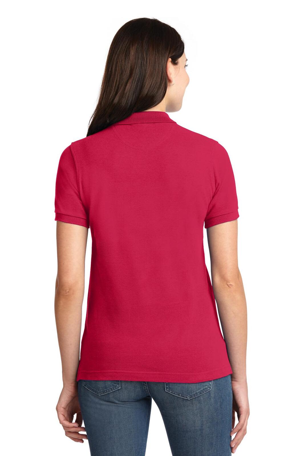 A woman wearing a pink polo shirt, viewed from the back, showcasing the shirt's short sleeves and fit.