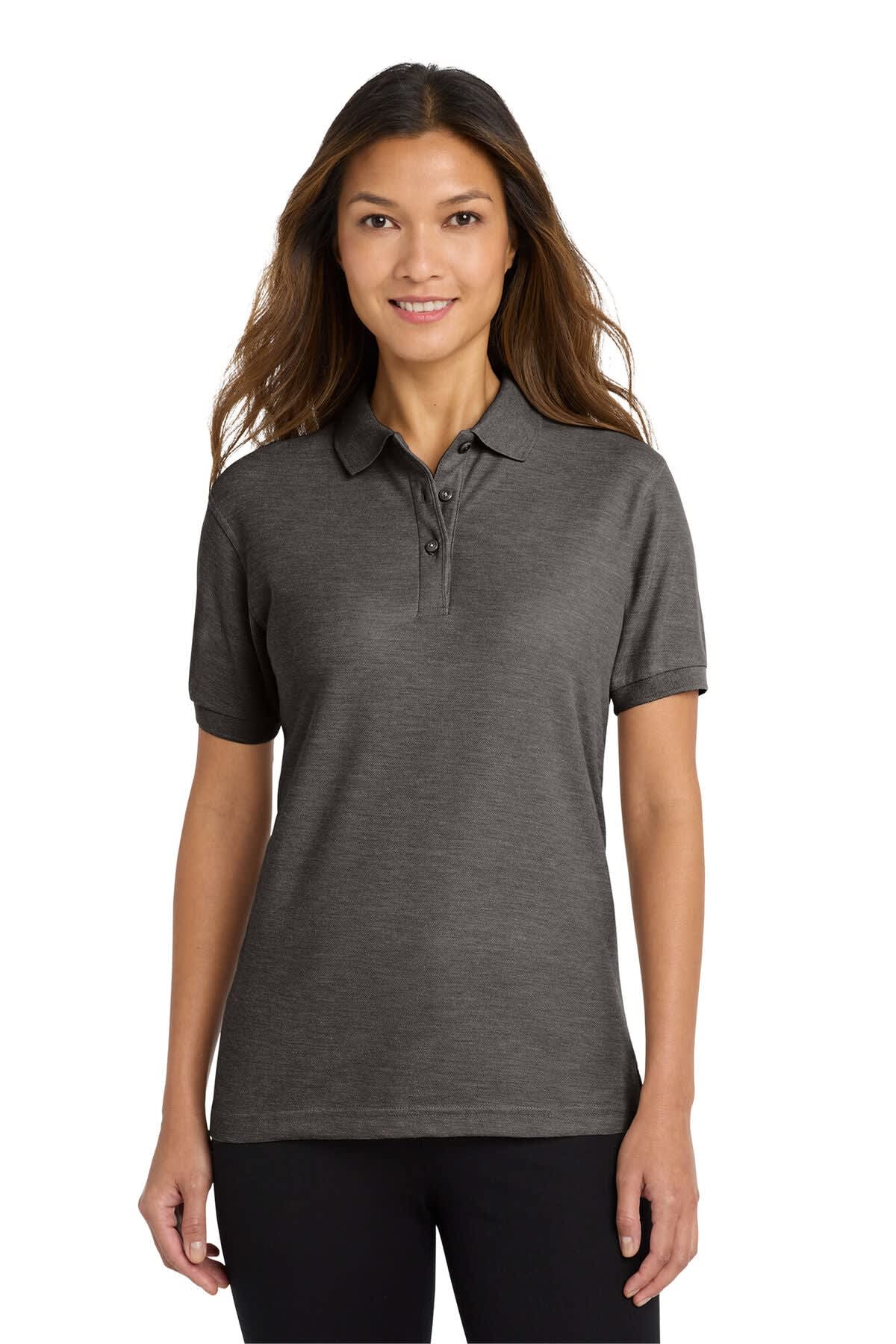 A woman models a dark grey Port Authority Ladies Silk Touch Polo shirt. The shirt features a collar and short sleeves.