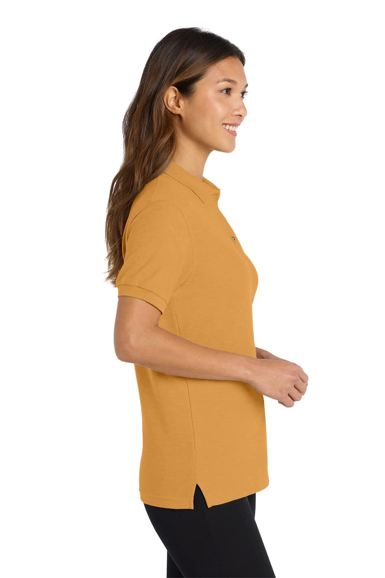 A lady wearing a gold silk touch polo shirt, featuring a collar and side slits, paired with black pants.