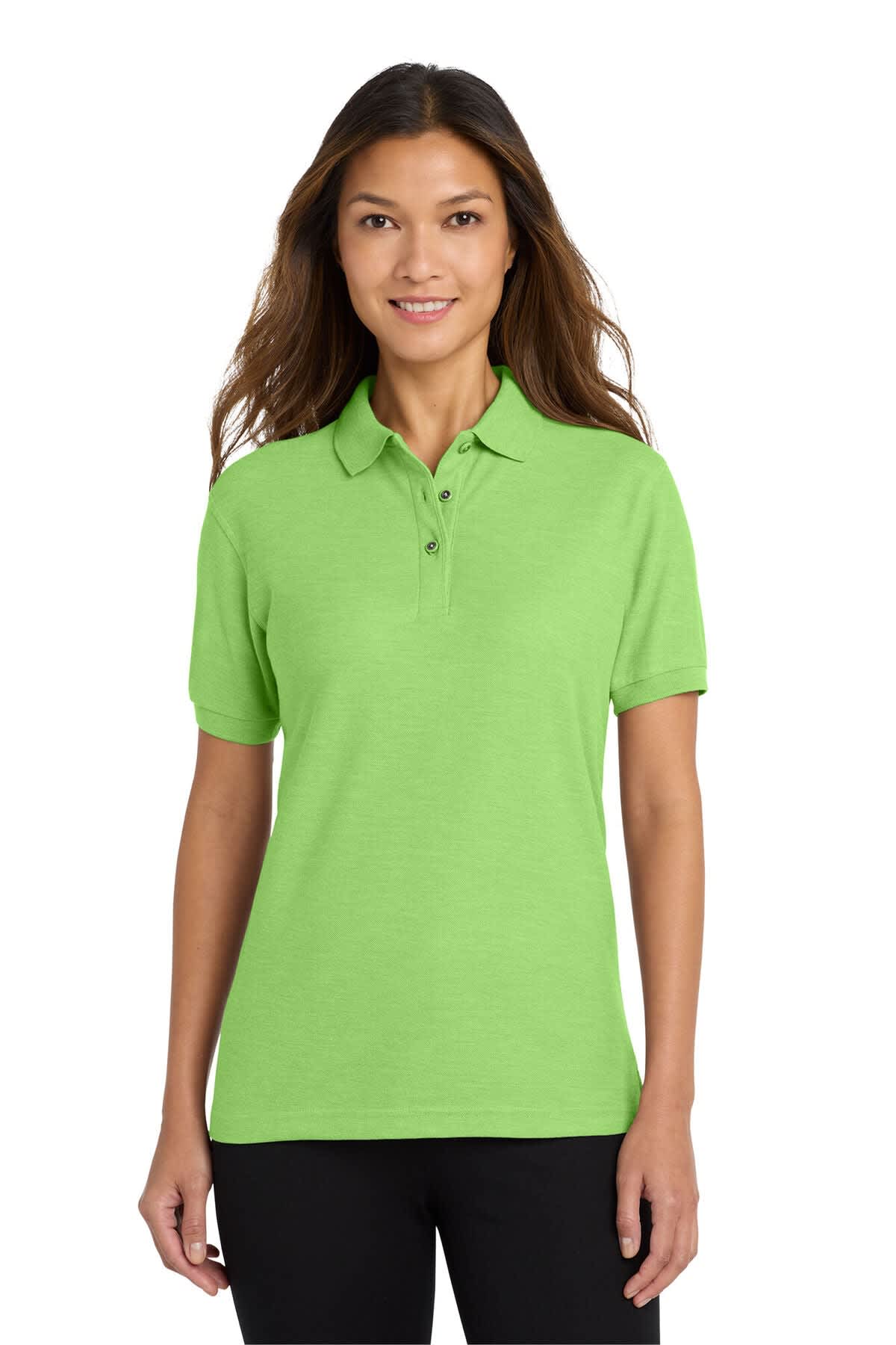 A green polo shirt featuring a collar and short sleeves, modelled by a woman with long hair. It has a logo on it.