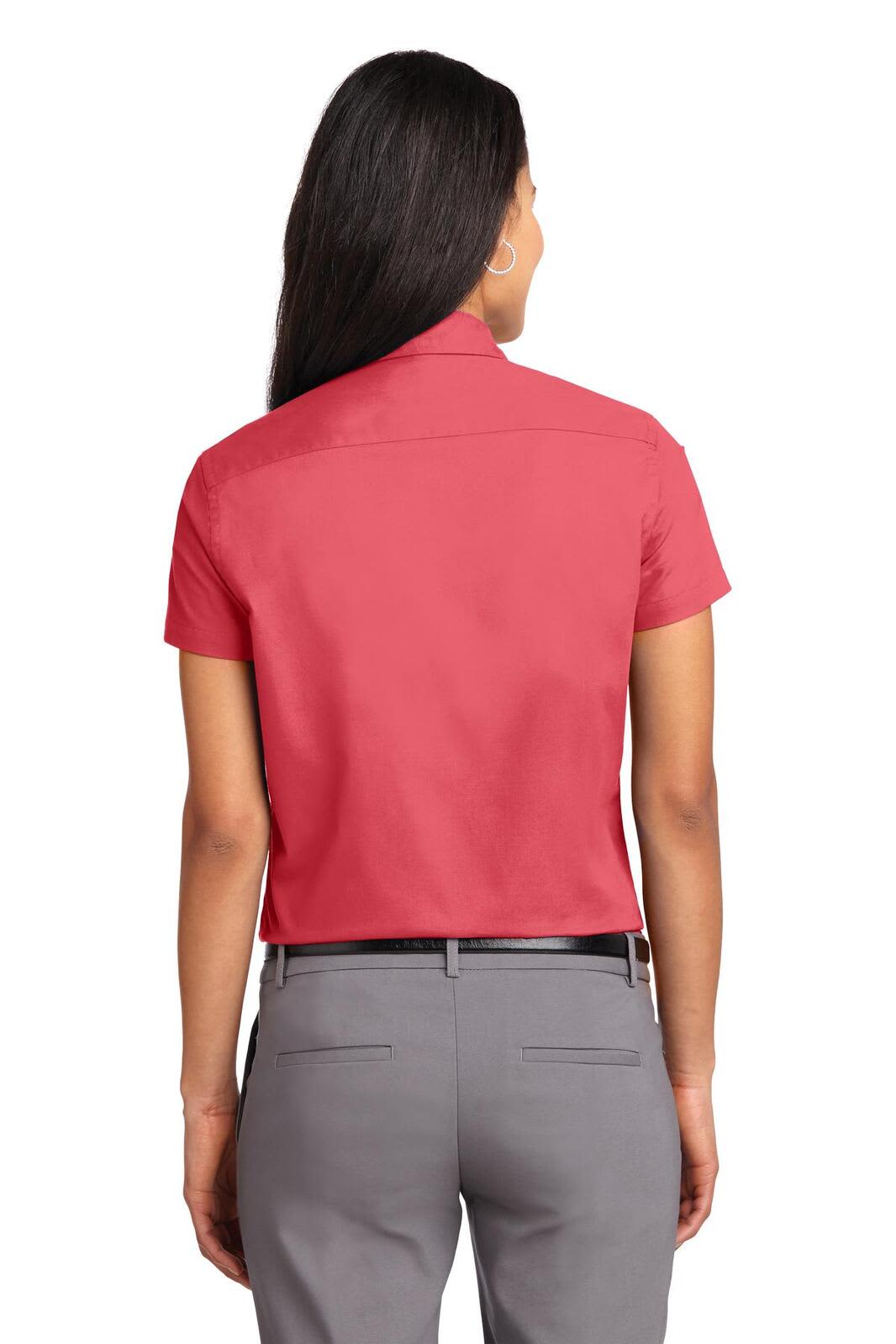 A red short sleeve button-up shirt with a classic collar, featuring a branded logo on the back.