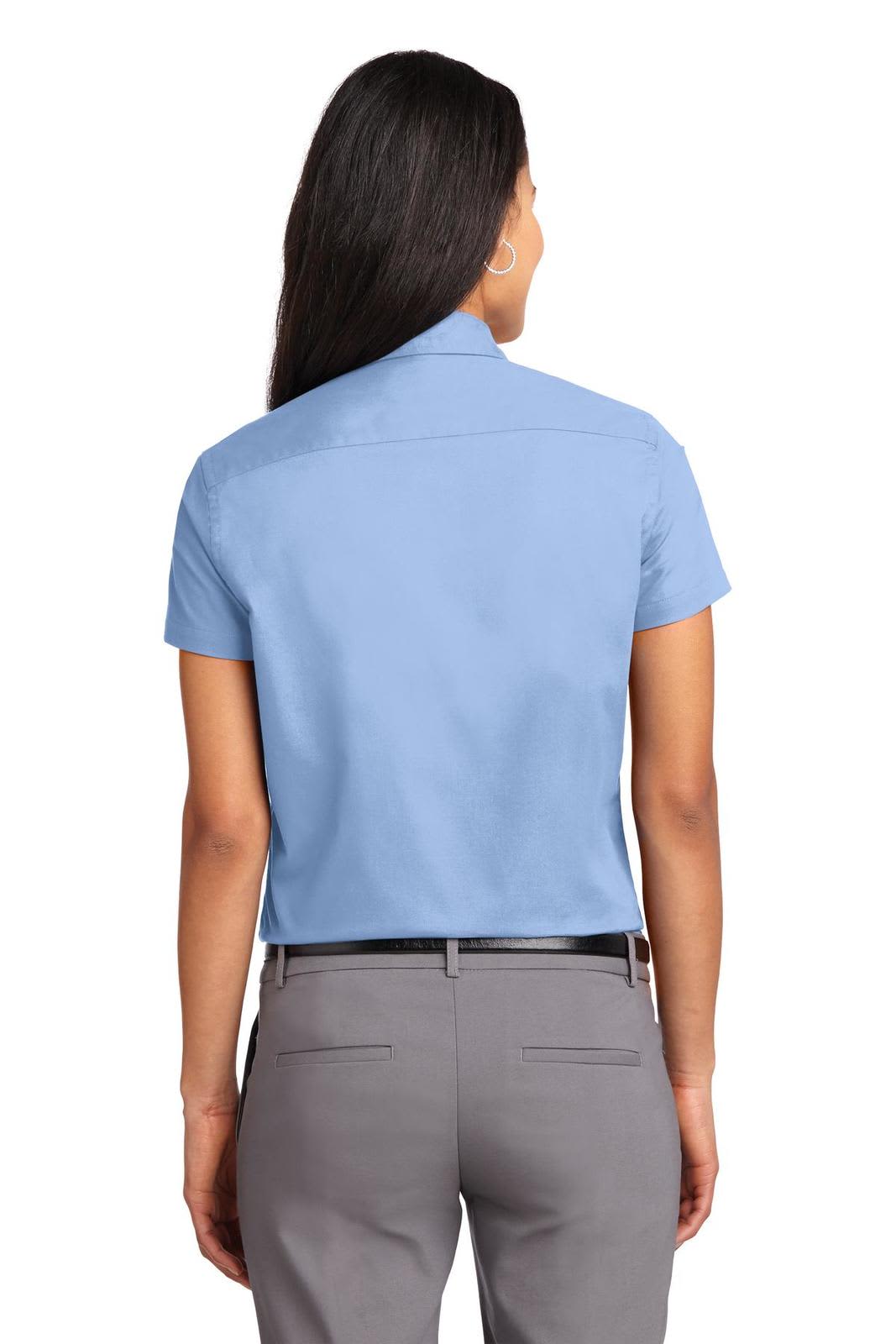 A back view of a light blue short sleeve button-up shirt with a logo on the collar.
