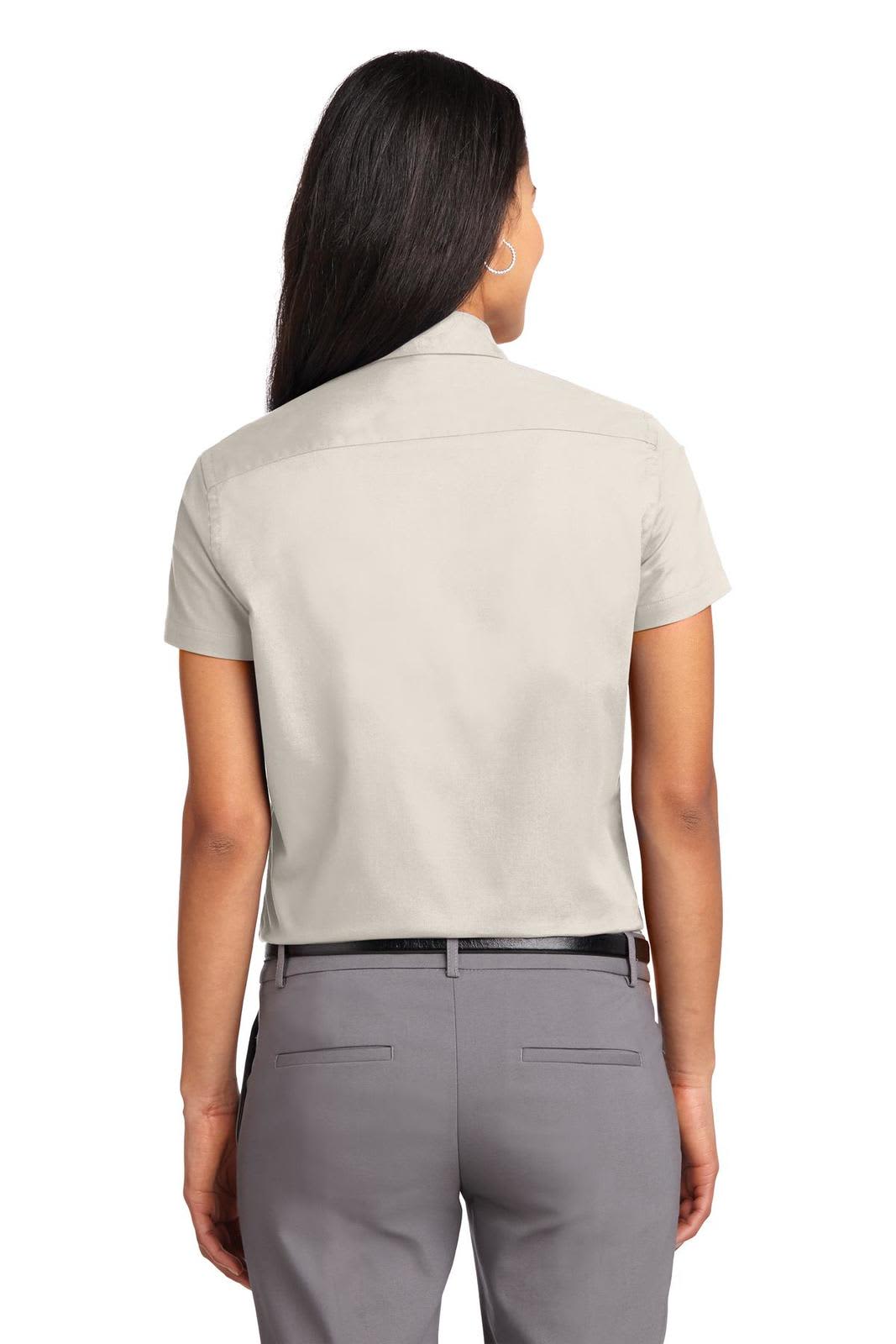 A light grey short sleeve button-up shirt with a collar, featuring a back view. Includes a small logo on the back.