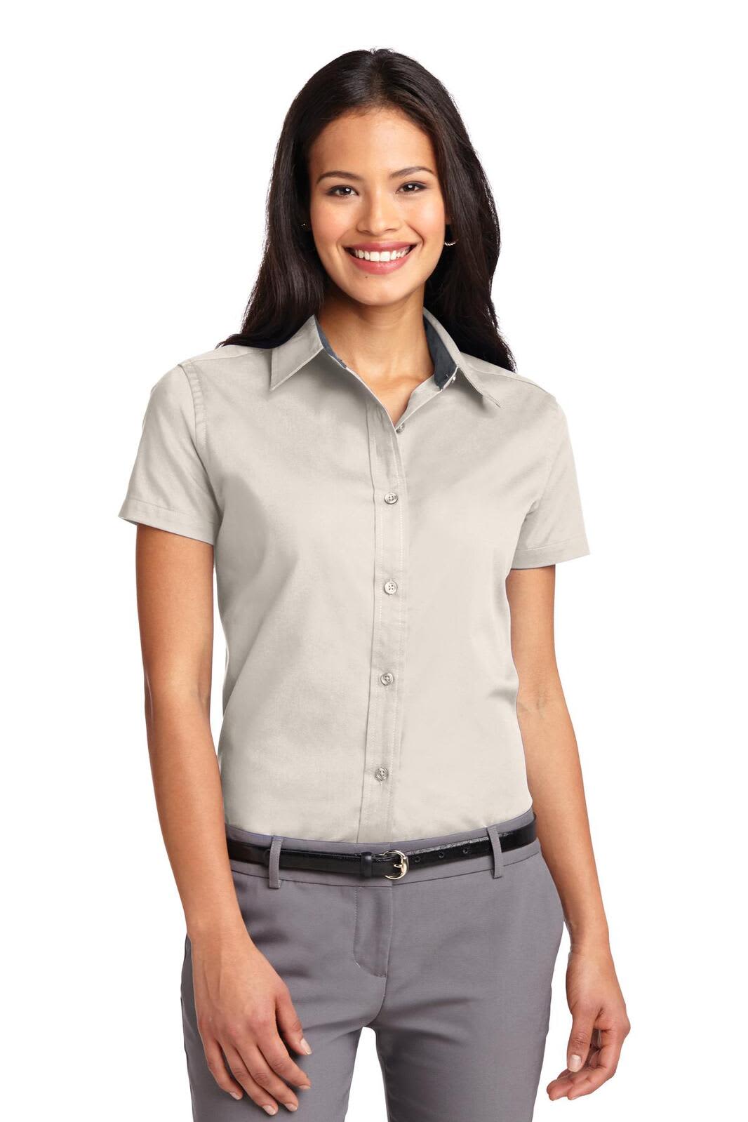 A light grey button-up shirt with short sleeves, featuring a collar and a logo on the chest.