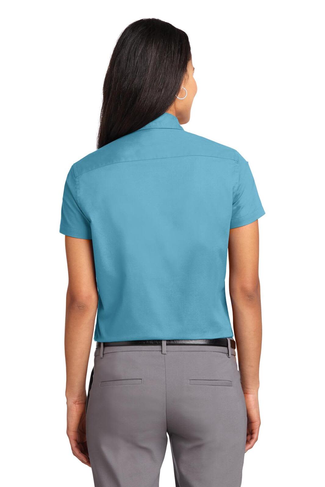 A back view of a women's short sleeve button-up shirt in teal, featuring a collar and a logo.