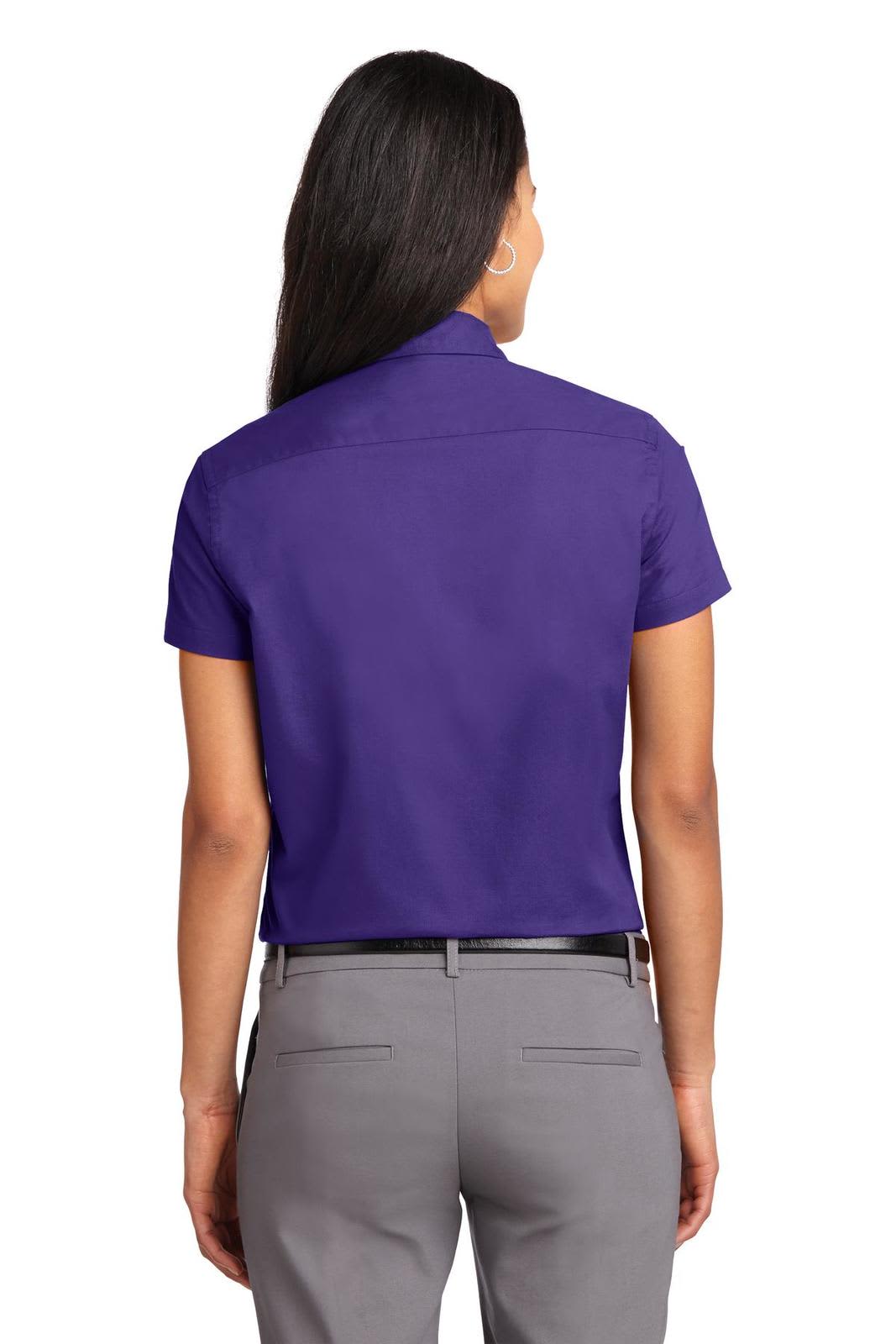 A purple short sleeve button-up shirt with a collar, view from the back, featuring a logo.