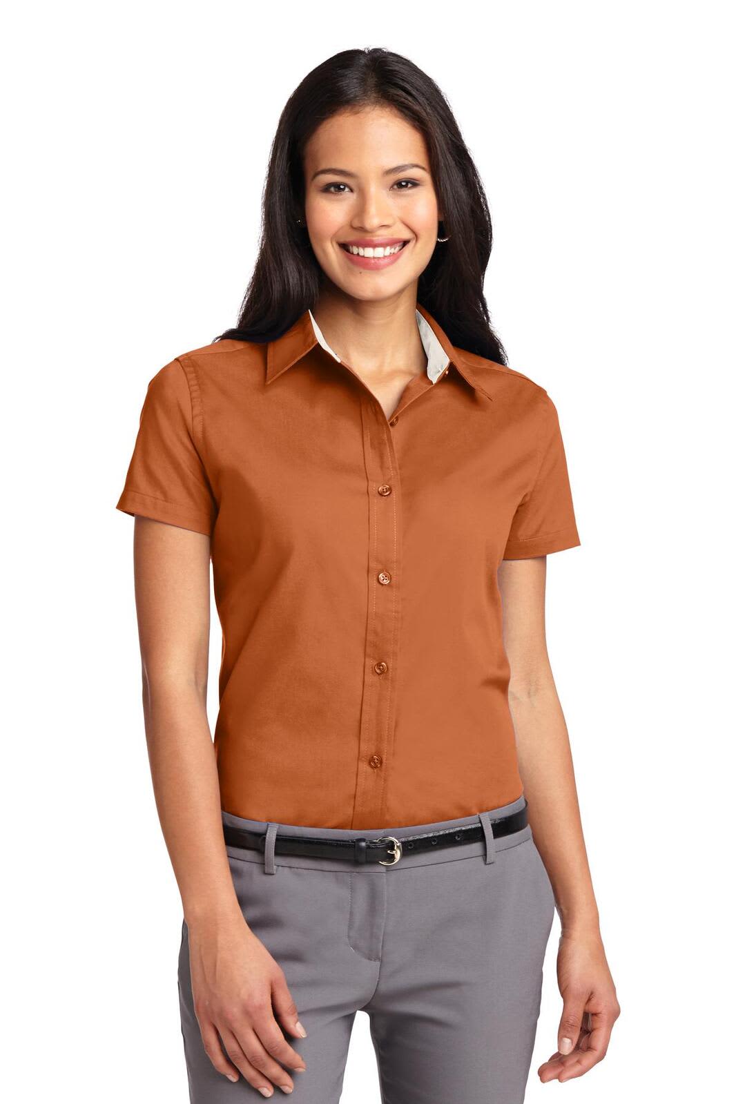 A woman wearing a brown short-sleeve button-up shirt with a white collar. The shirt features a logo.