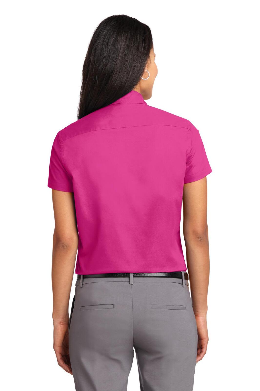 A short sleeve women's button-up shirt in bright pink, showcasing a smooth back design. Includes a logo.