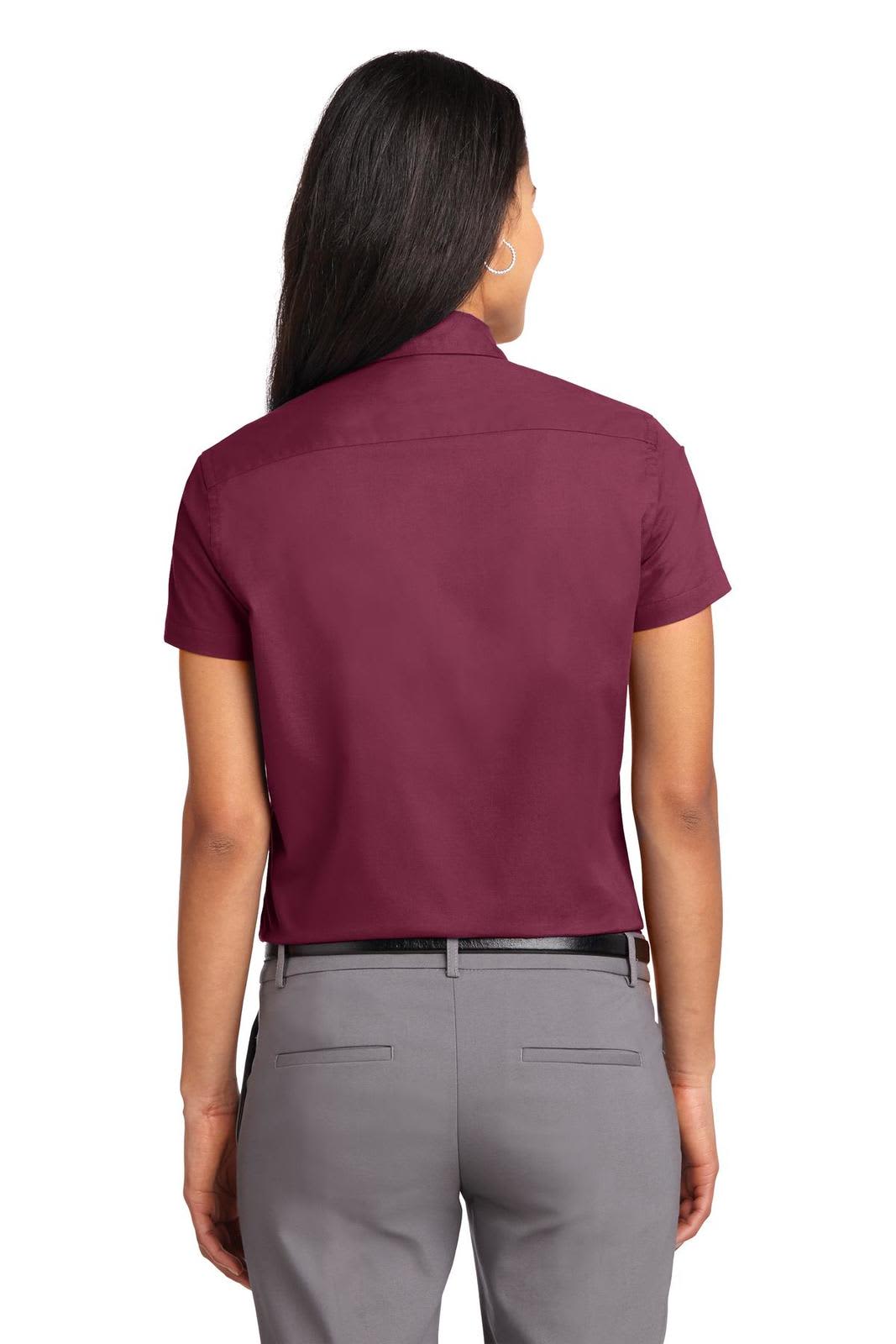 A back view of a maroon short sleeve button-up shirt, featuring a collar and a logo.