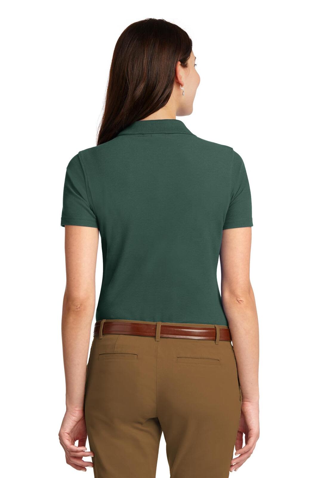 A green ladies' polo shirt with short sleeves, featuring a collar and a logo on the back.