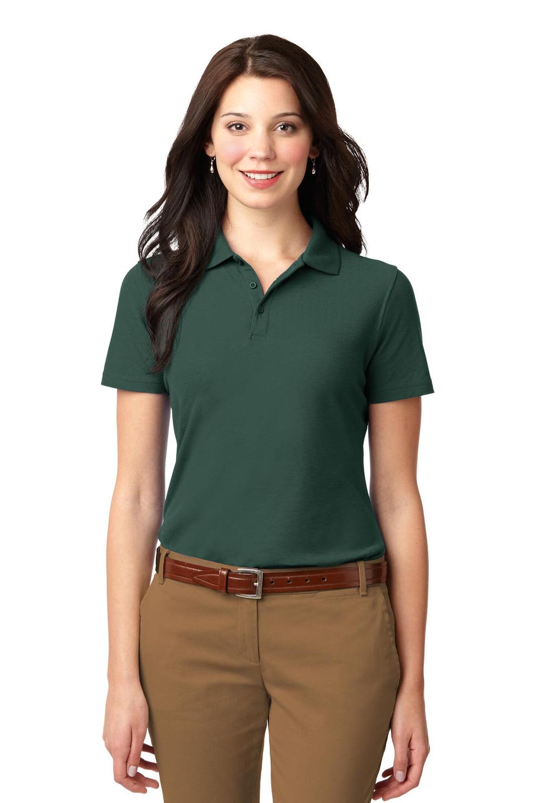 A dark green women's polo shirt with a collar, paired with brown trousers. The shirt features a logo.