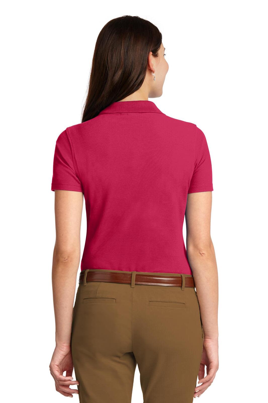 A pink stain-resistant polo shirt for women, featuring a fitted design and short sleeves, viewed from the back.