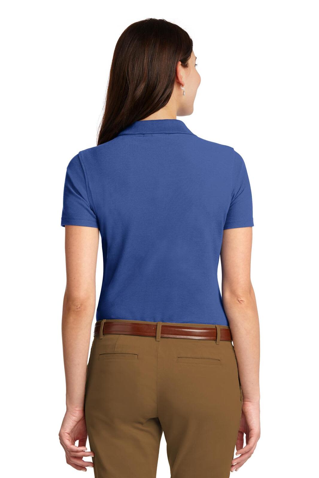 A blue ladies’ polo shirt with a short sleeve, featuring a subtle branding detail on the back.