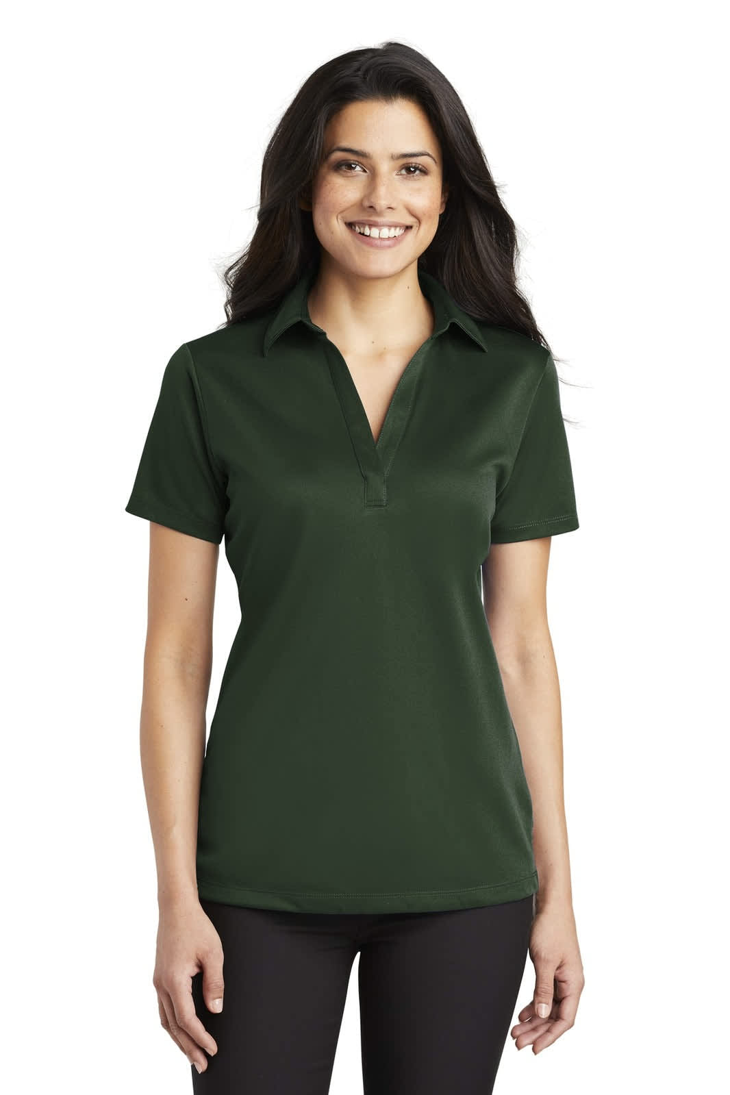 A lady wearing a dark green silk touch performance polo shirt with a collar and short sleeves, featuring a logo.