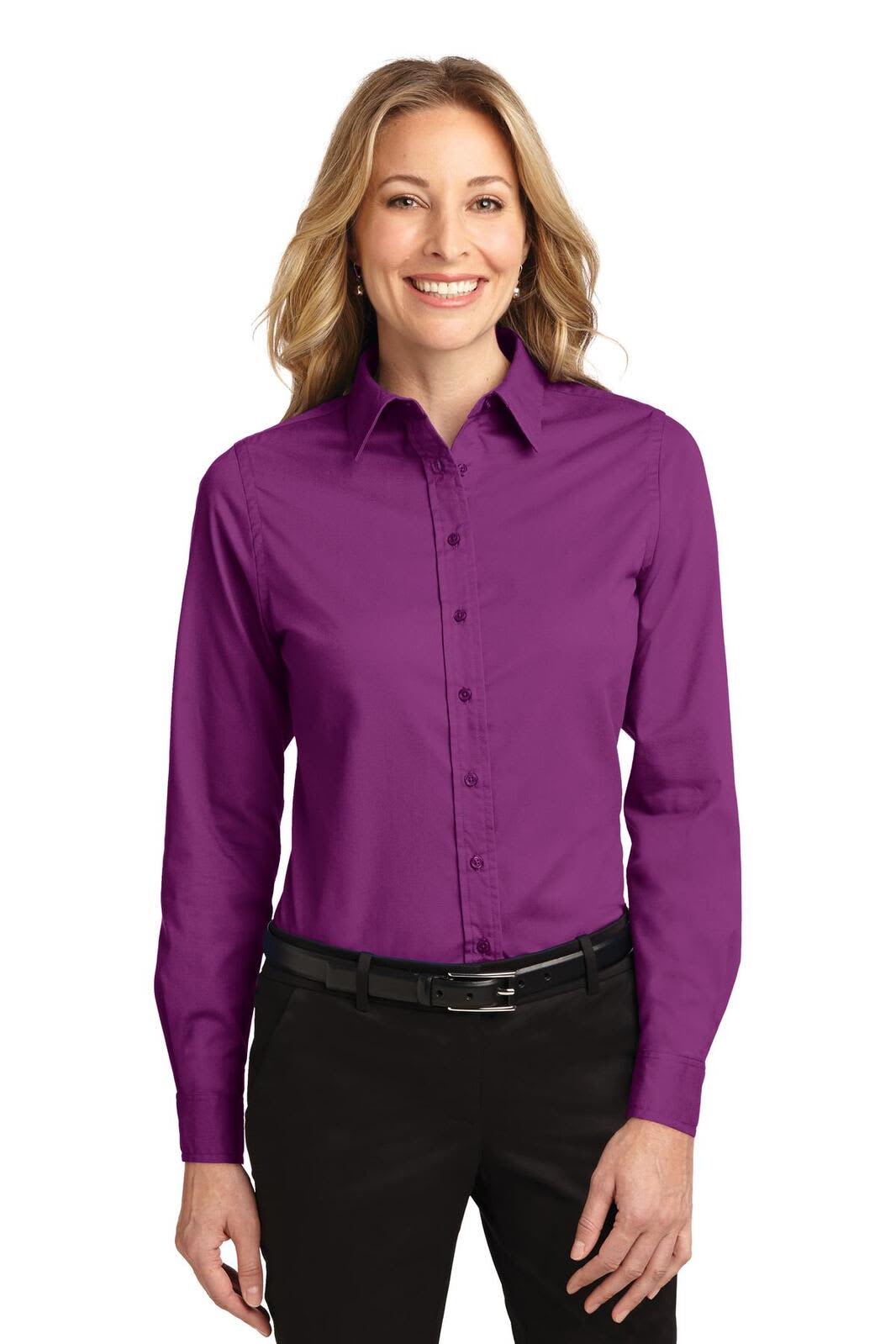 A purple long sleeve button-up shirt for women, featuring a collar and a sleek fit. There is a logo on the shirt.