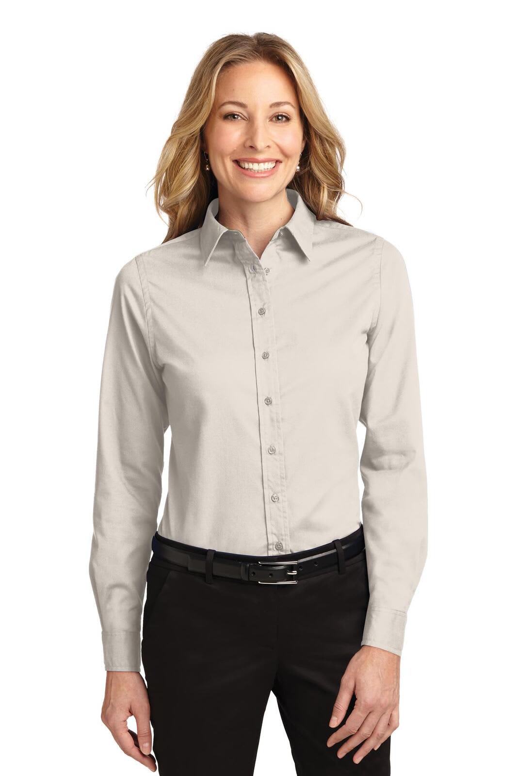 A long sleeve, button-up shirt in light grey, featuring a collar and a logo on the left side.